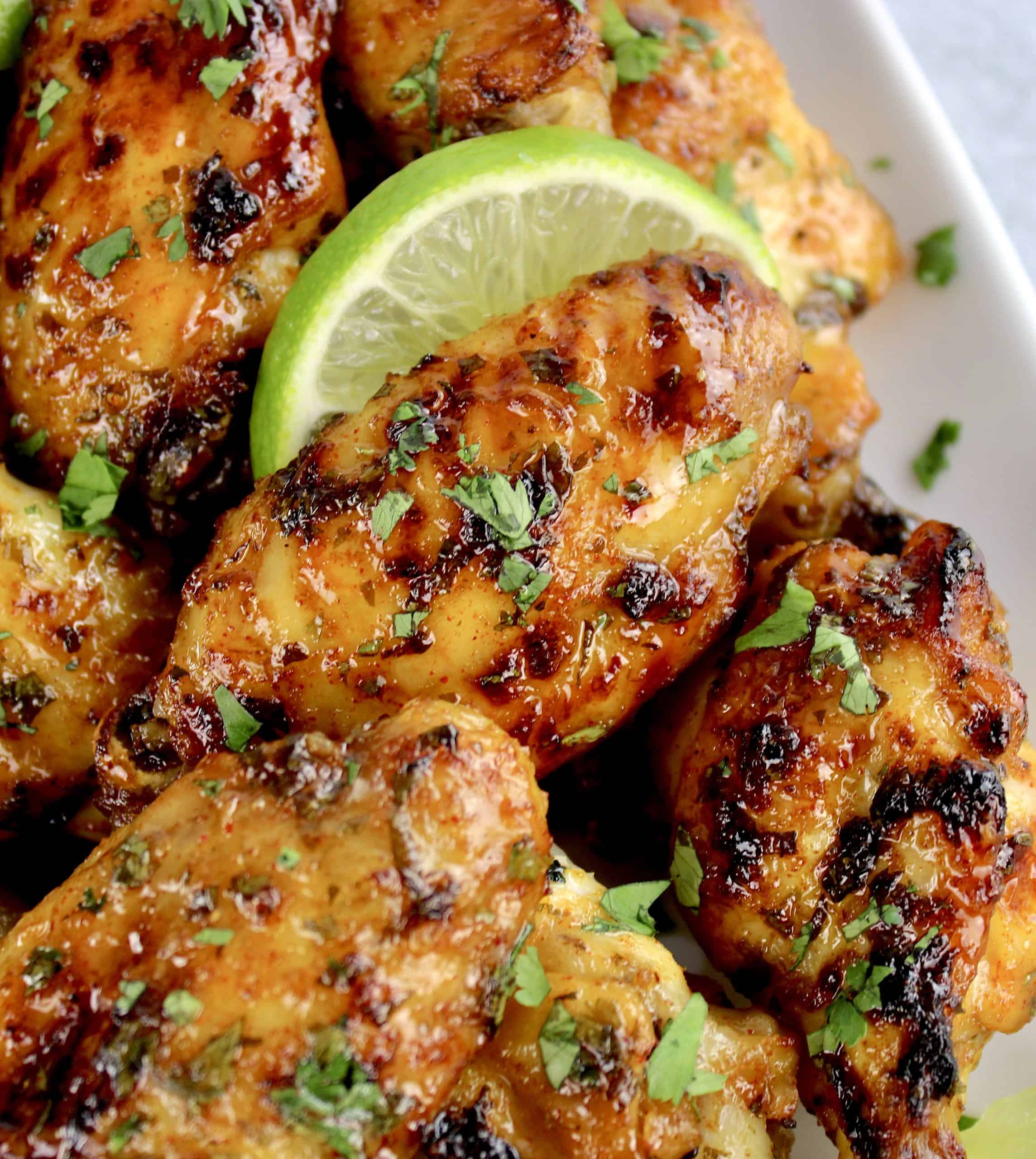 Cilantro Lime Chicken Wings with lime slice on white plate