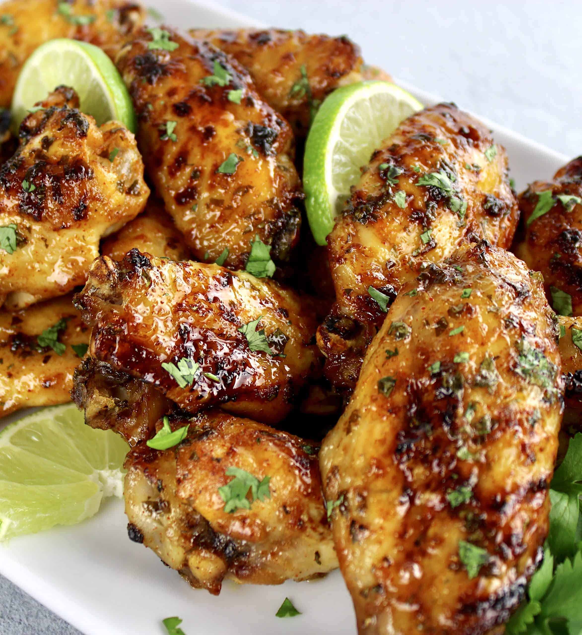 Cilantro Lime Chicken Wings on white plate with lime slices