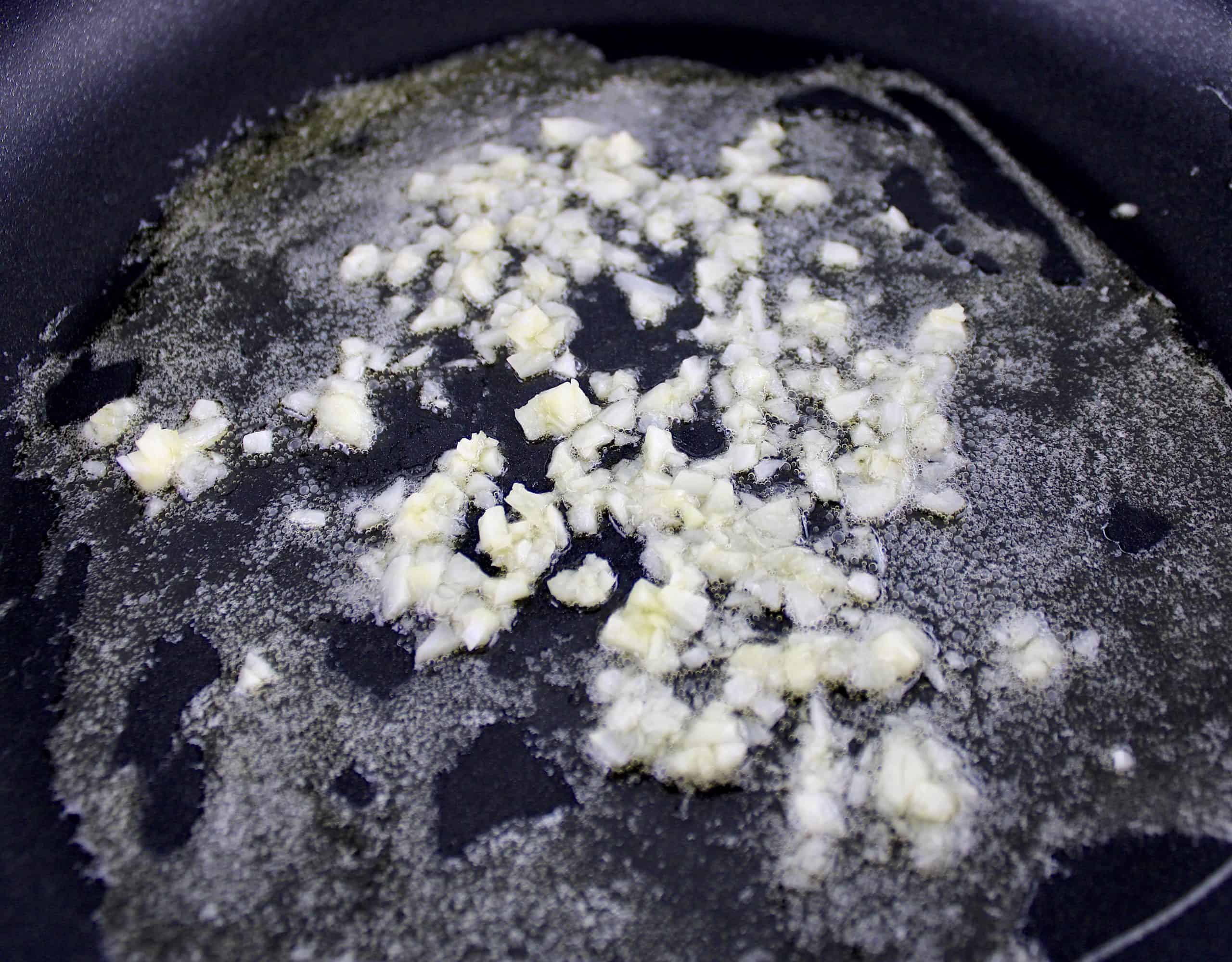 garlic sautéing in butter in skillet