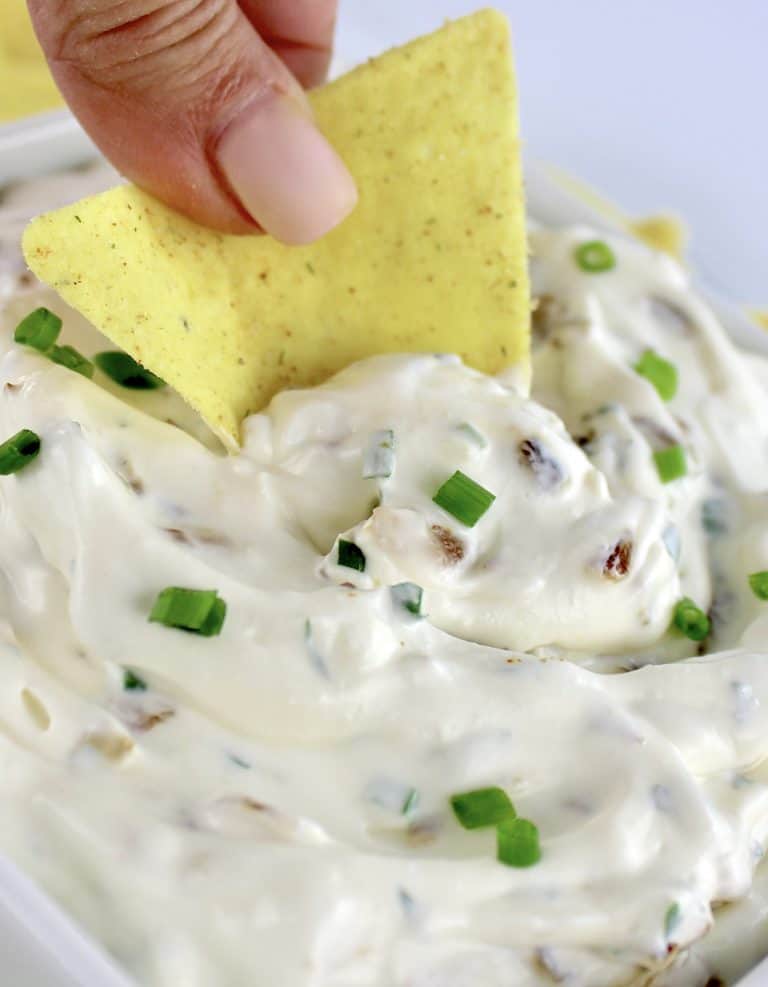 chip being dipped into french onion dip