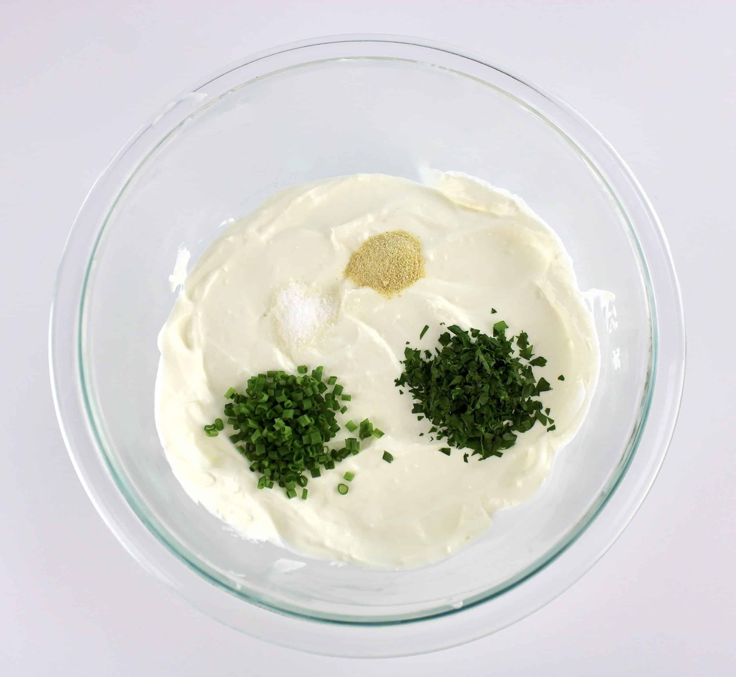 onion dip ingredients in glass bowl unmixed