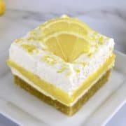 slice of Keto Lemon Lush on white plate with lemon slices on top