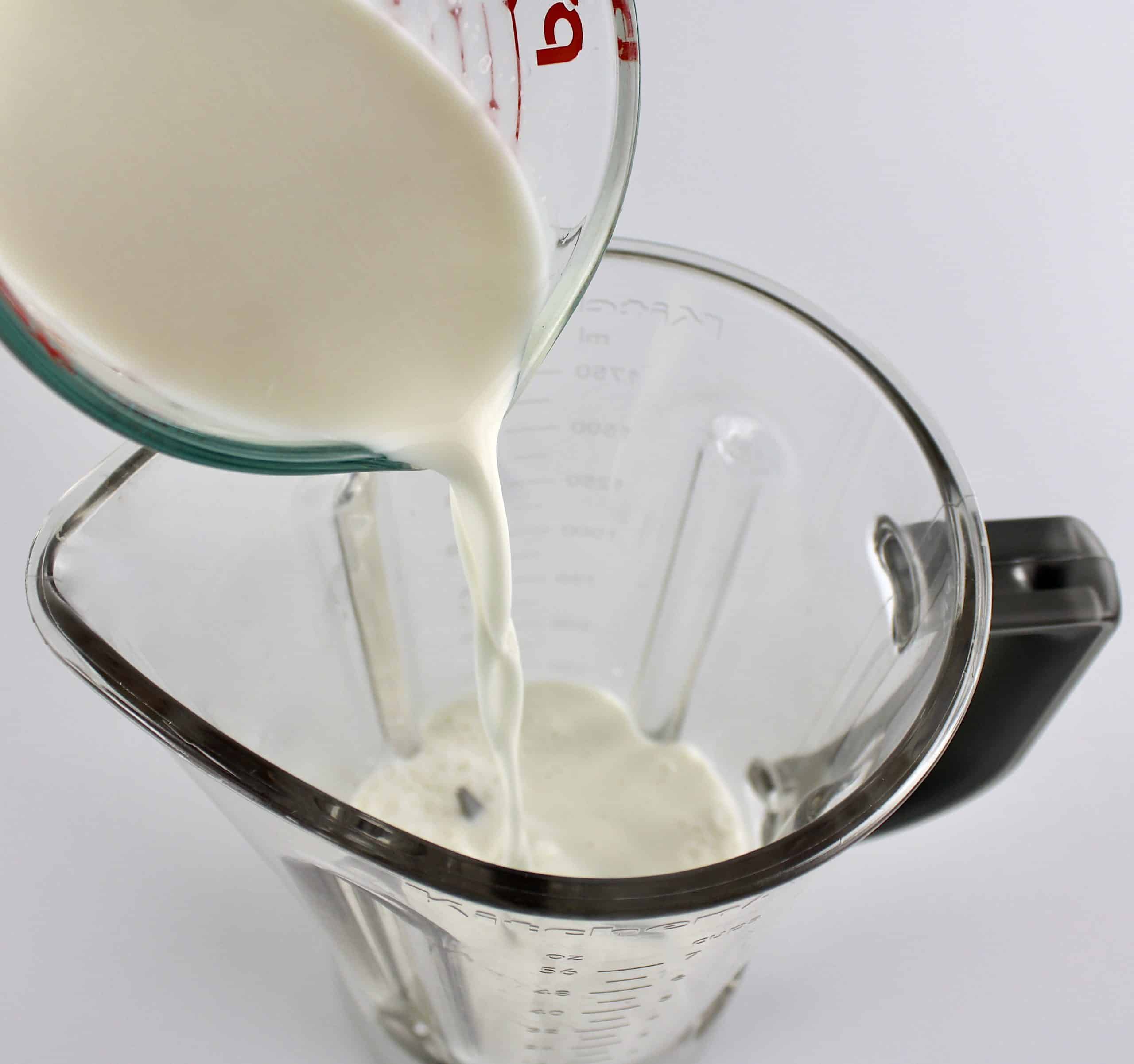 milk being poured into blender