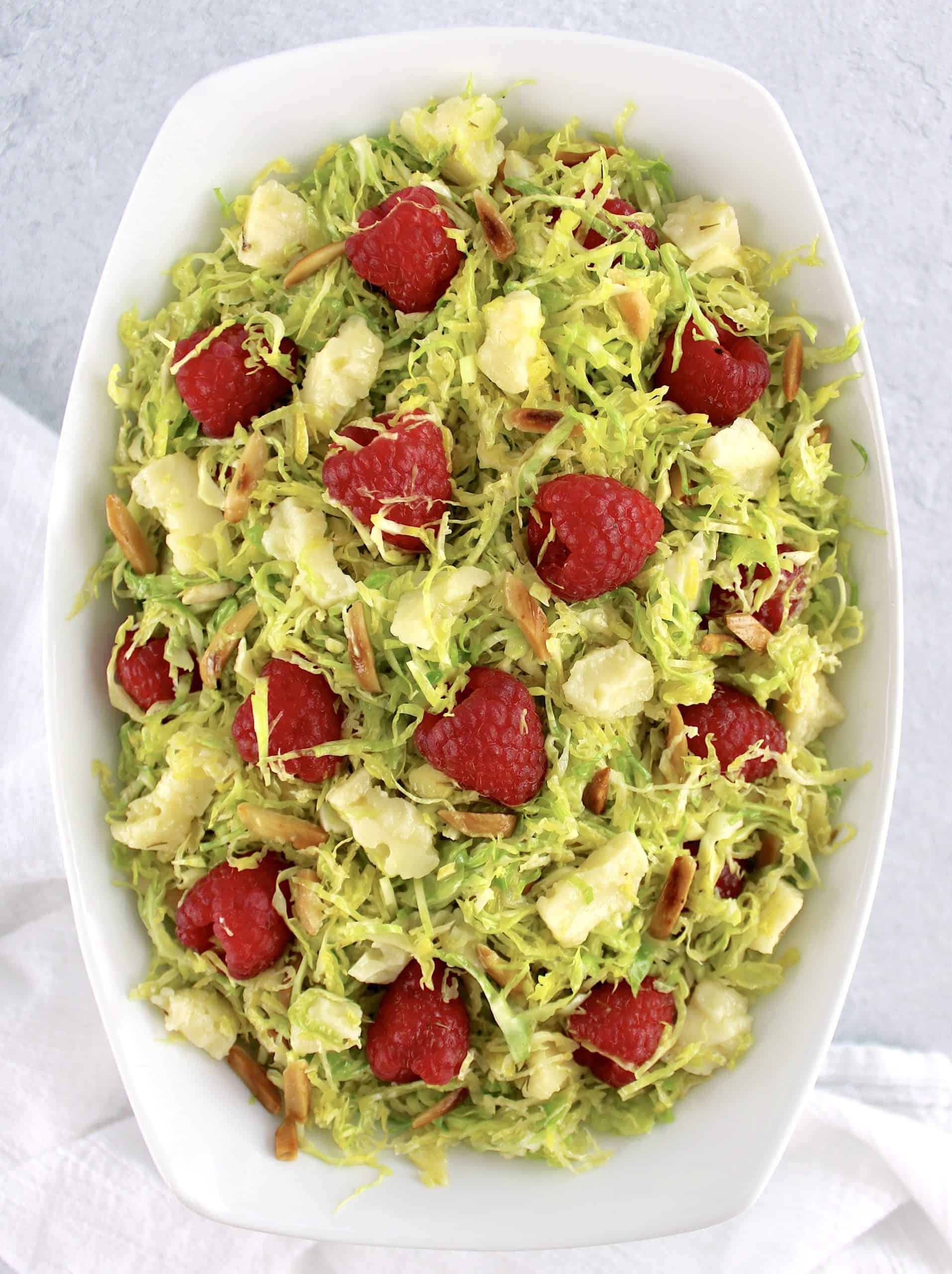 overhead view of Shaved Brussels Sprouts Salad with raspberries