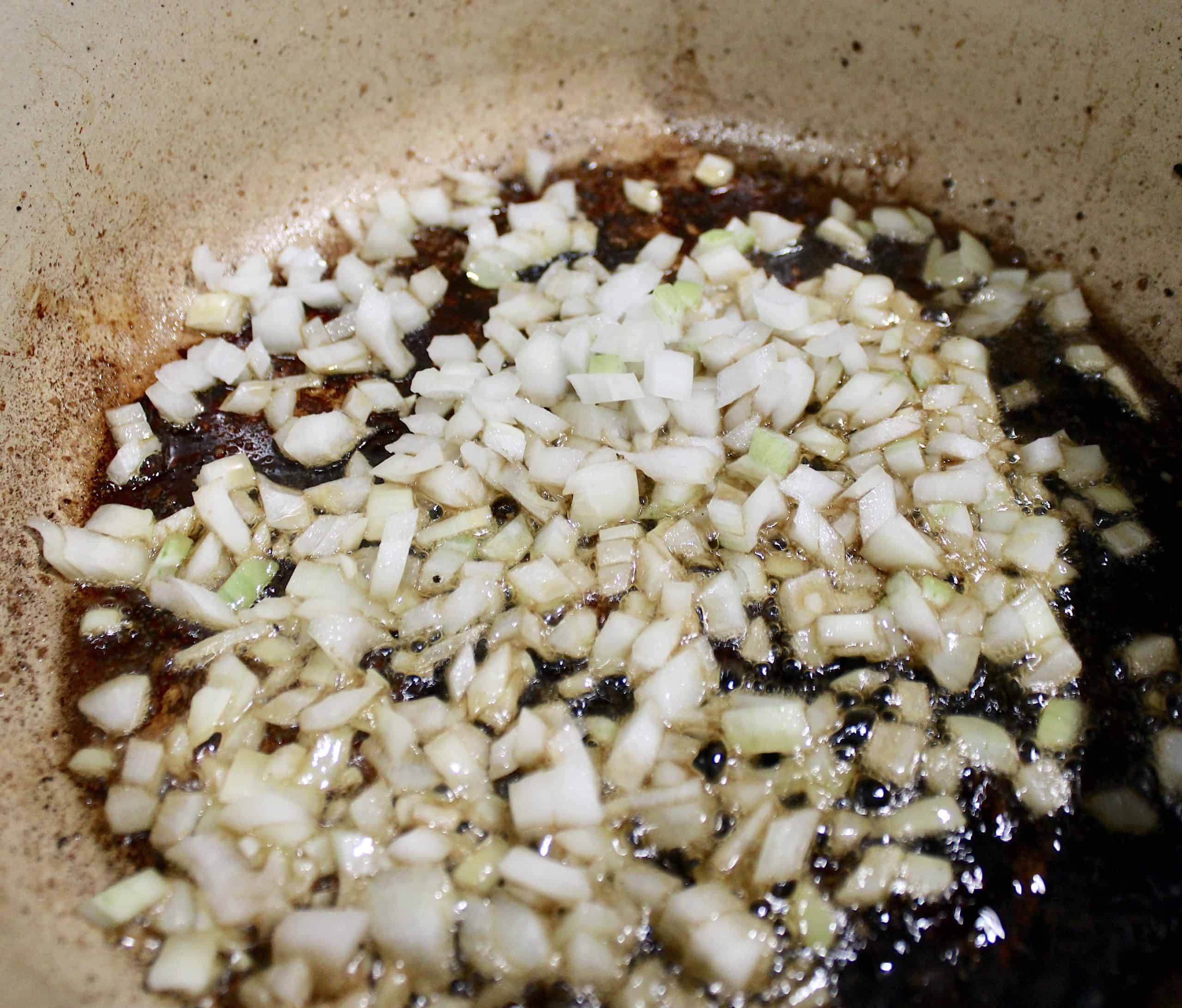 minced onions sauteing in skillet