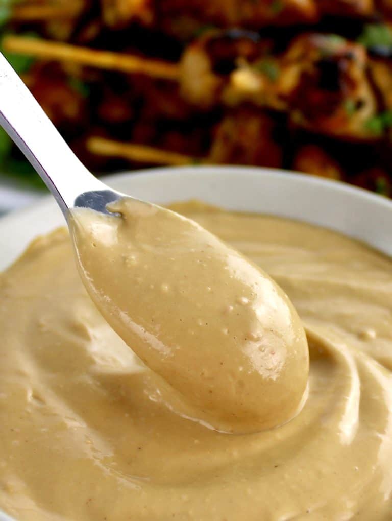 Easy Peanut Sauce in beige bowl with spoon scooping out some
