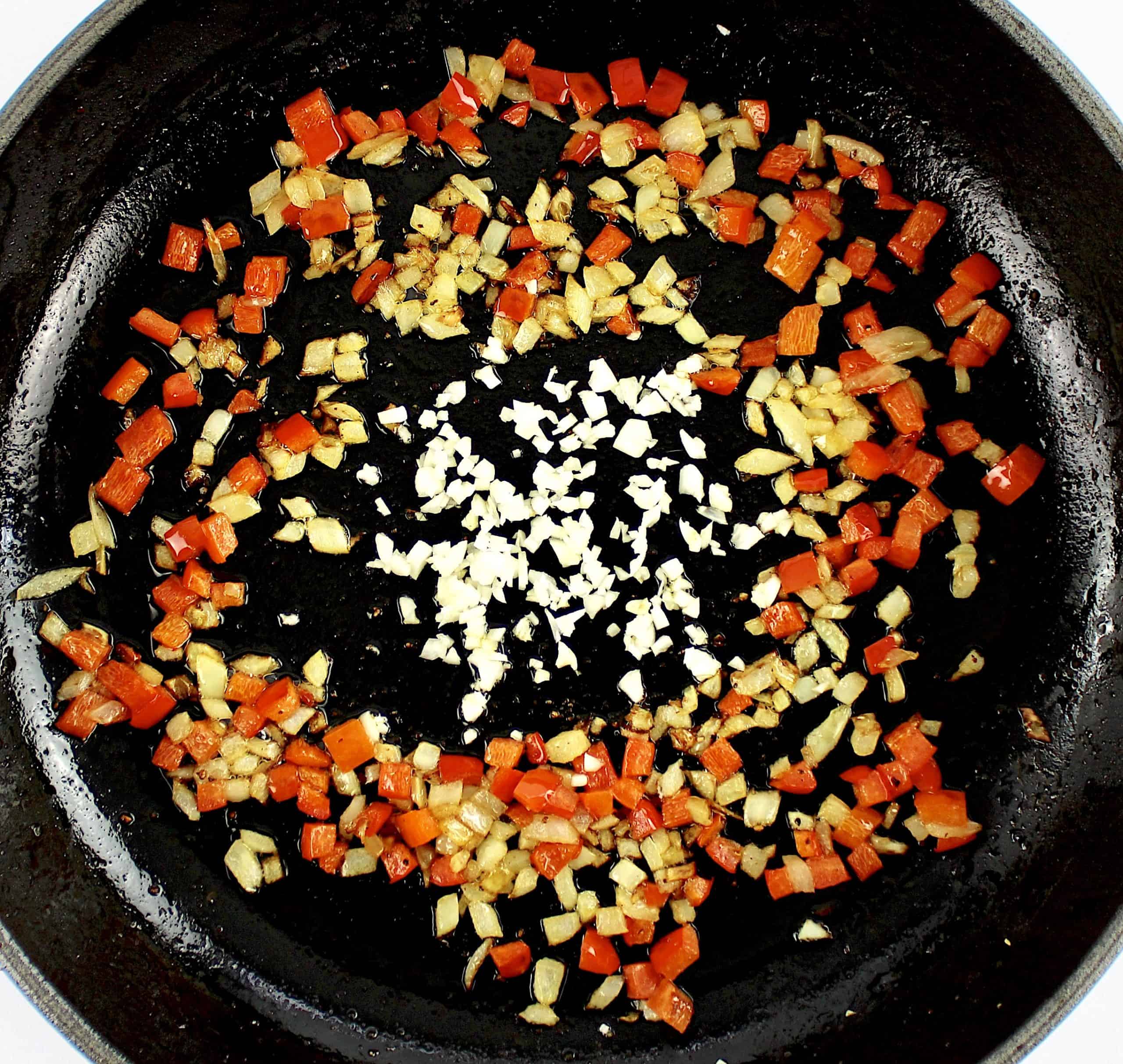 diced peppers, garlic and onions cooking in skillet