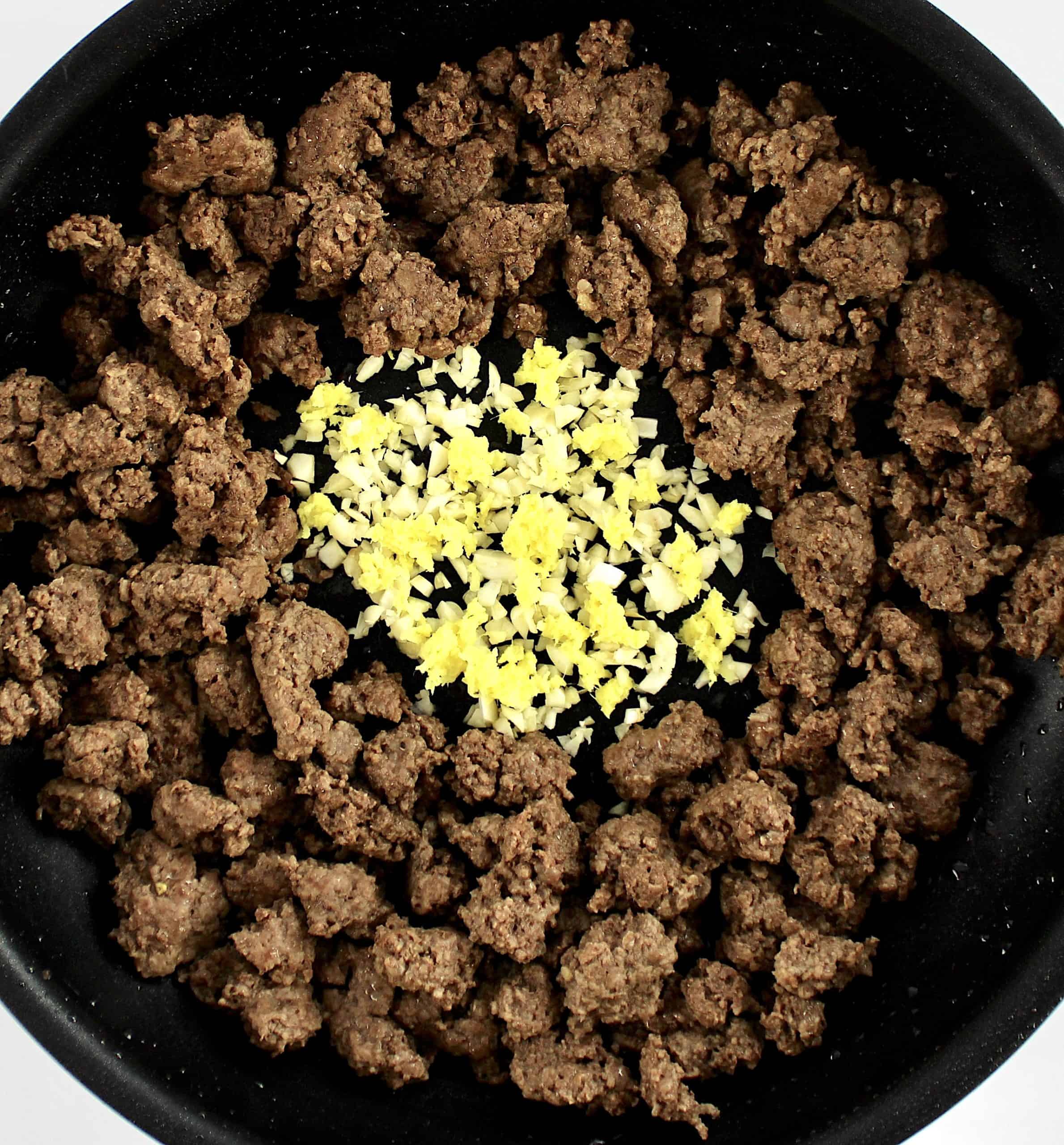 cooked ground beef with minced garlic and ginger in center
