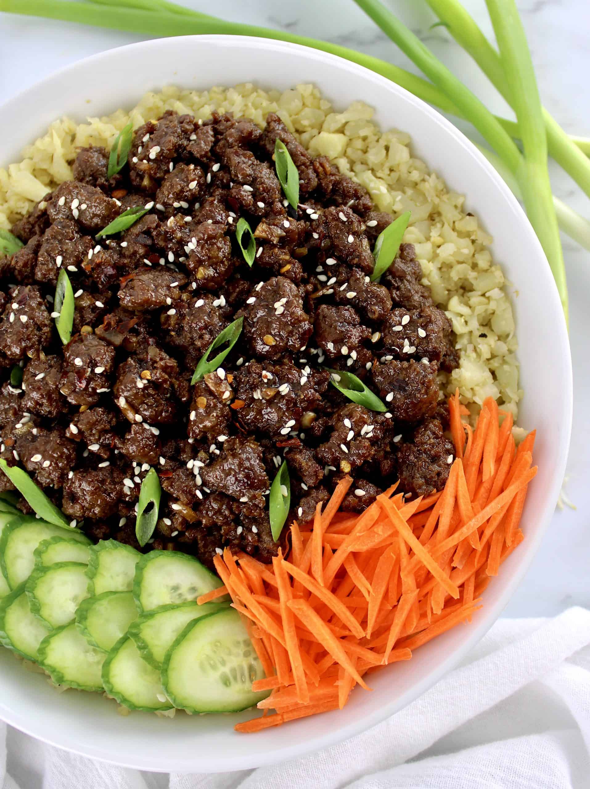 Korean Beef Bowl with sliced scallions and sesame seeds