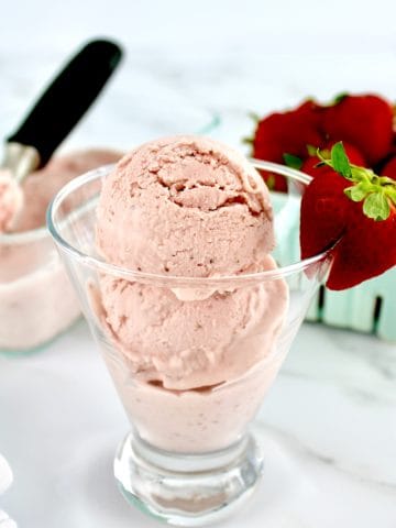 No Churn Keto Strawberry Ice Cream in glass with strawberry on side