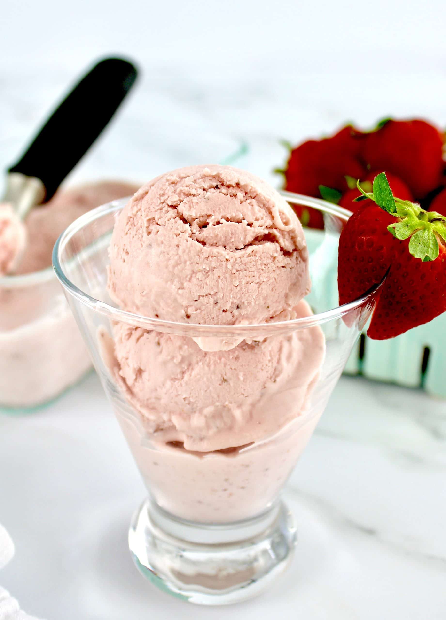 No Churn Keto Strawberry Ice Cream in glass with strawberry on side