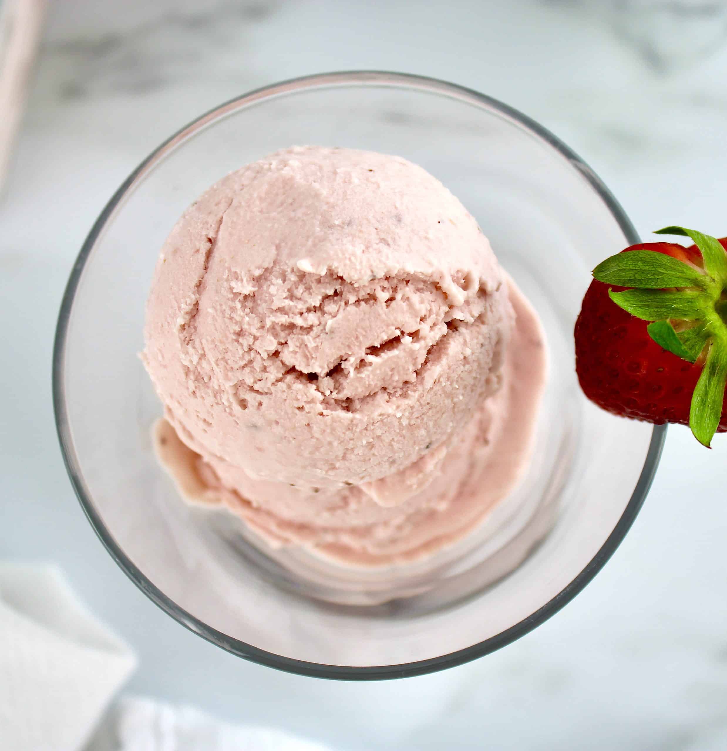 closeup overhead view of No Churn Keto Strawberry Ice Cream in glass bowl