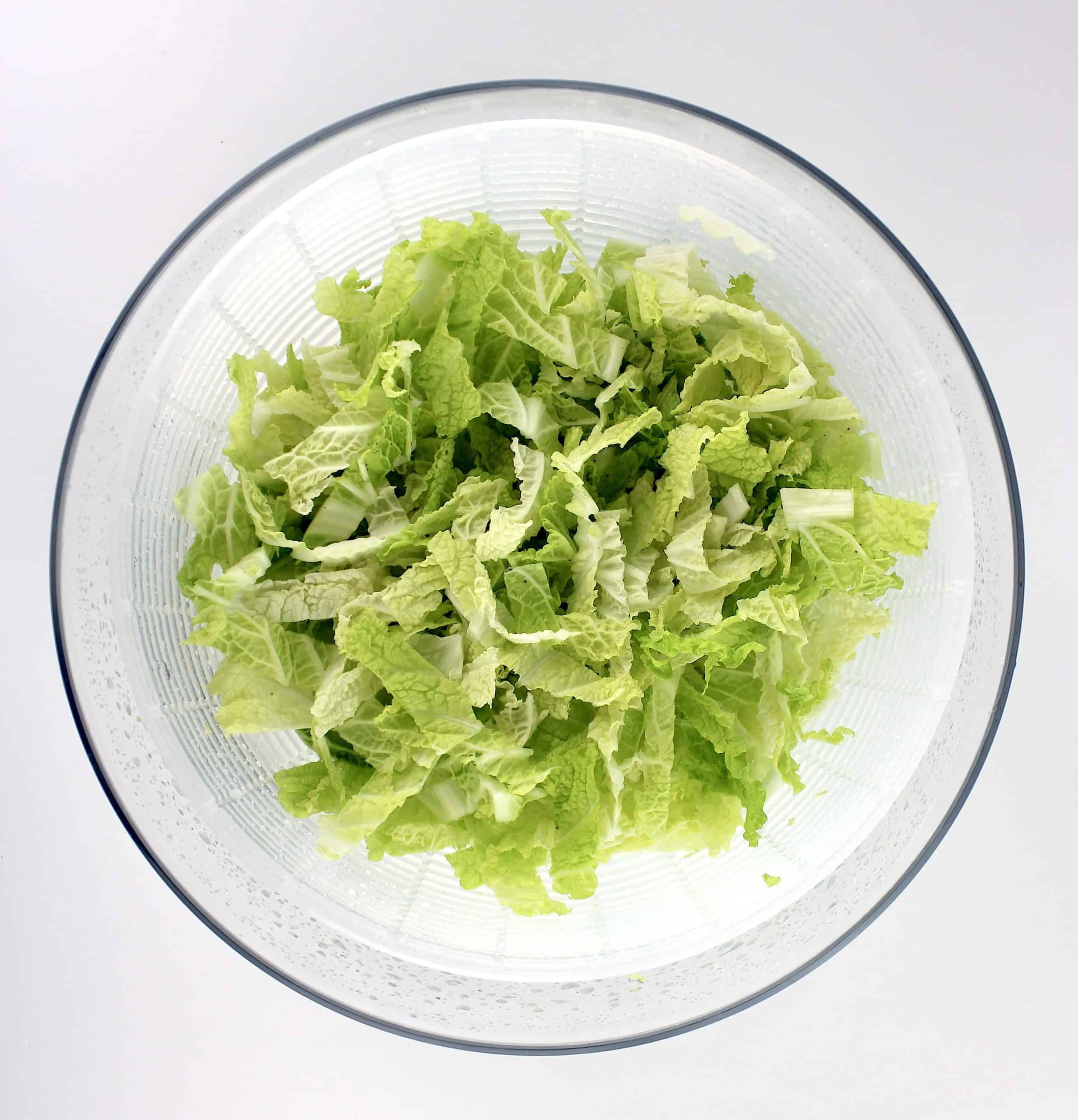 shredded napa cabbage in salad spinner bowl