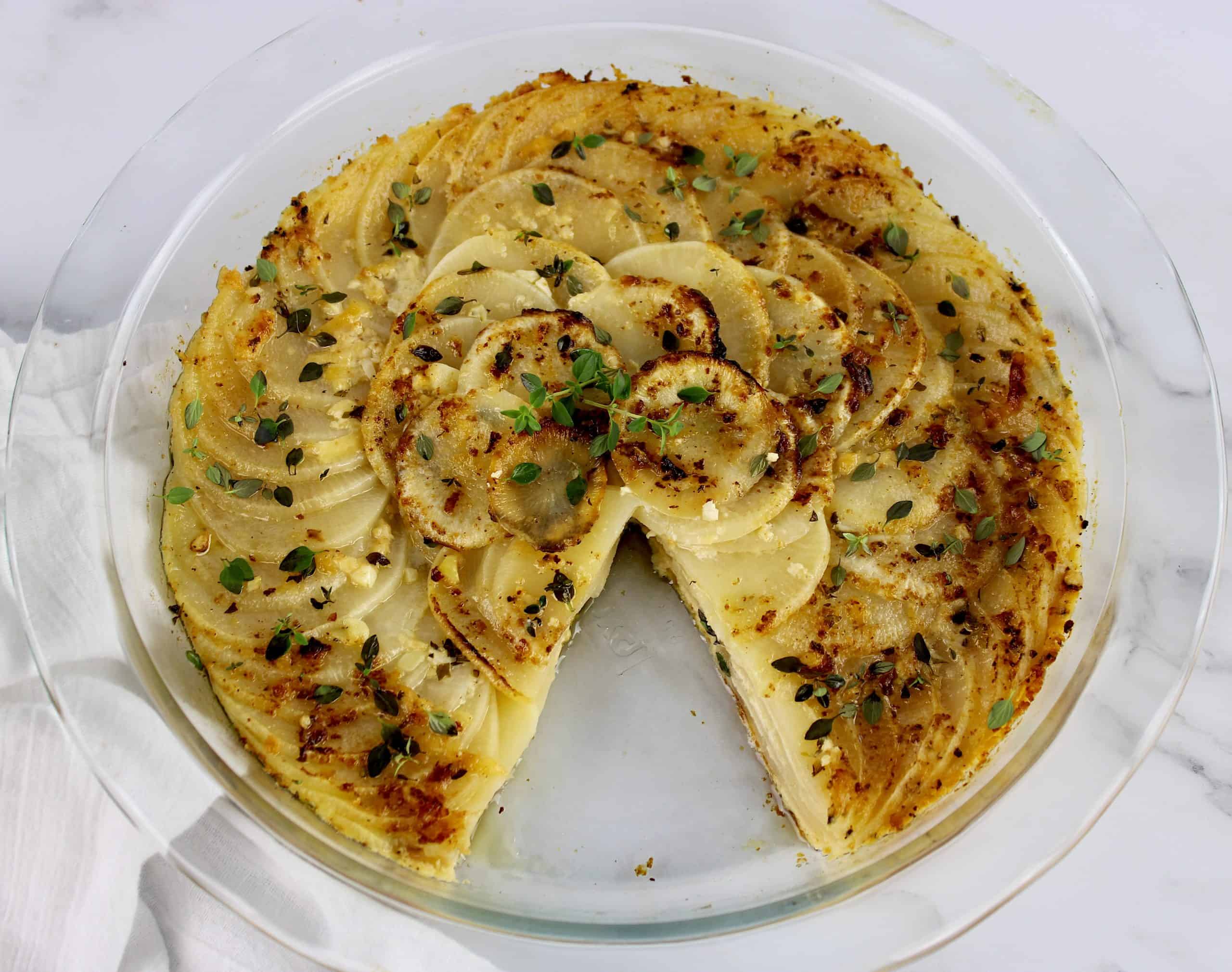 Turnips Au Gratin in glass pie dish with slice missing
