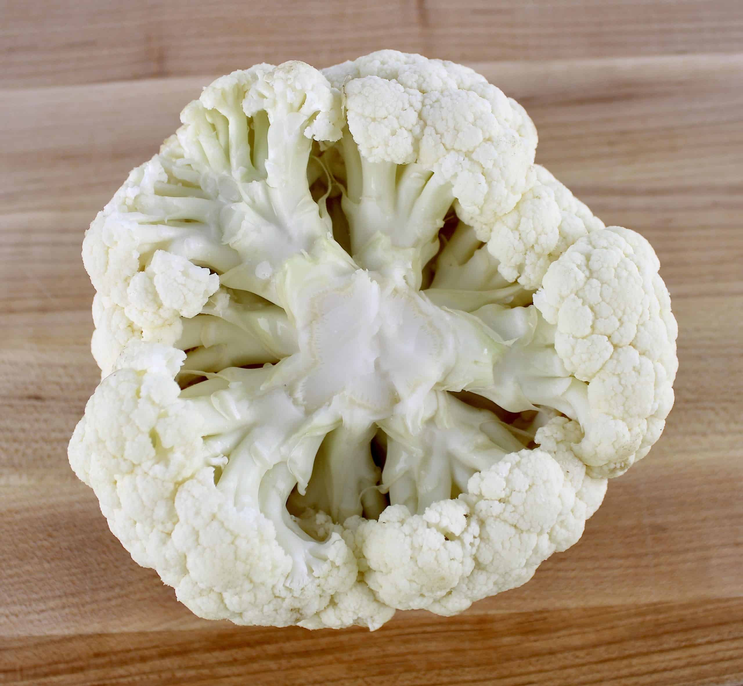 head of cauliflower upside down on cutting board