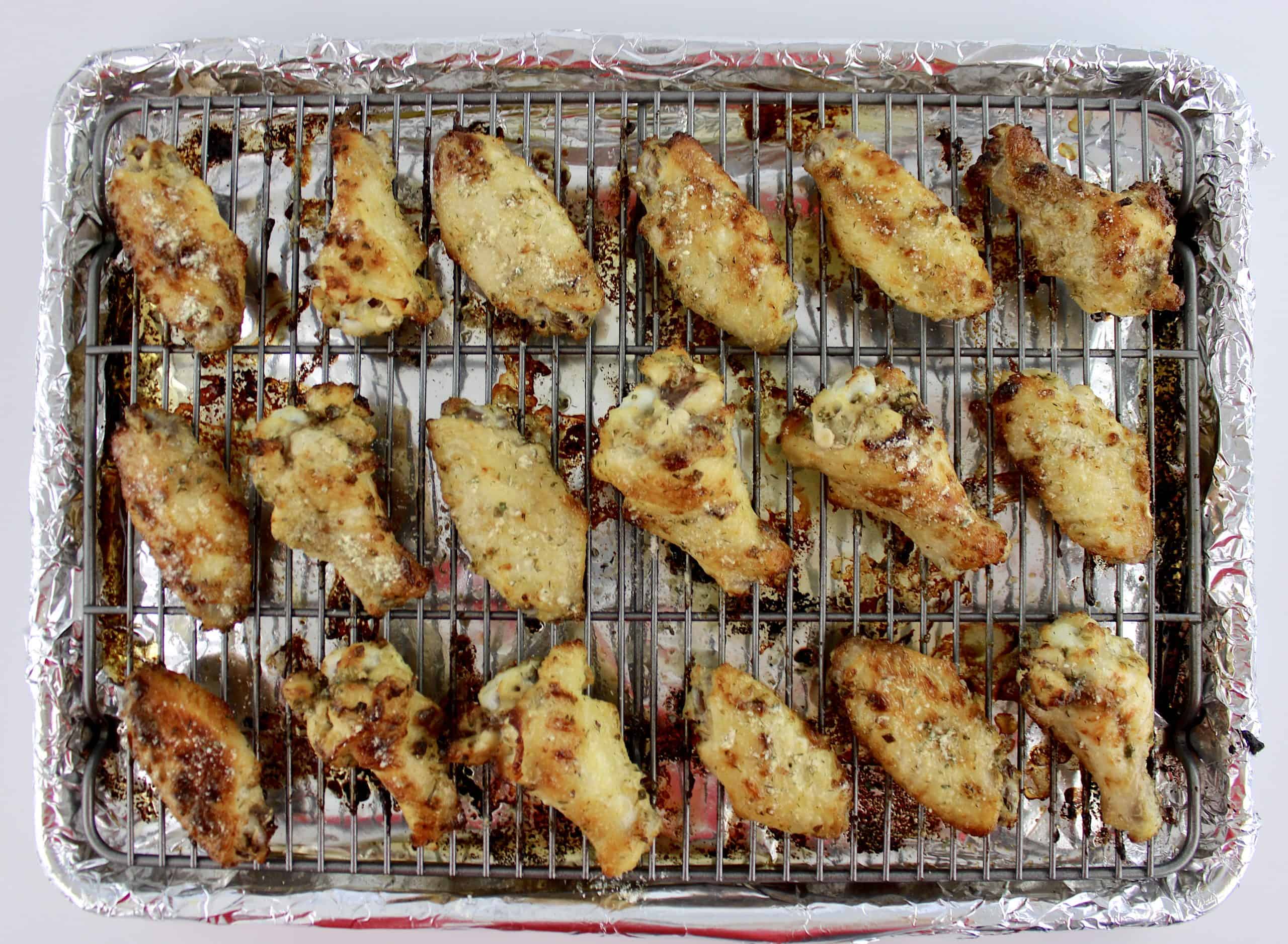 seasoned chicken wings on baking sheet with wire rack baked