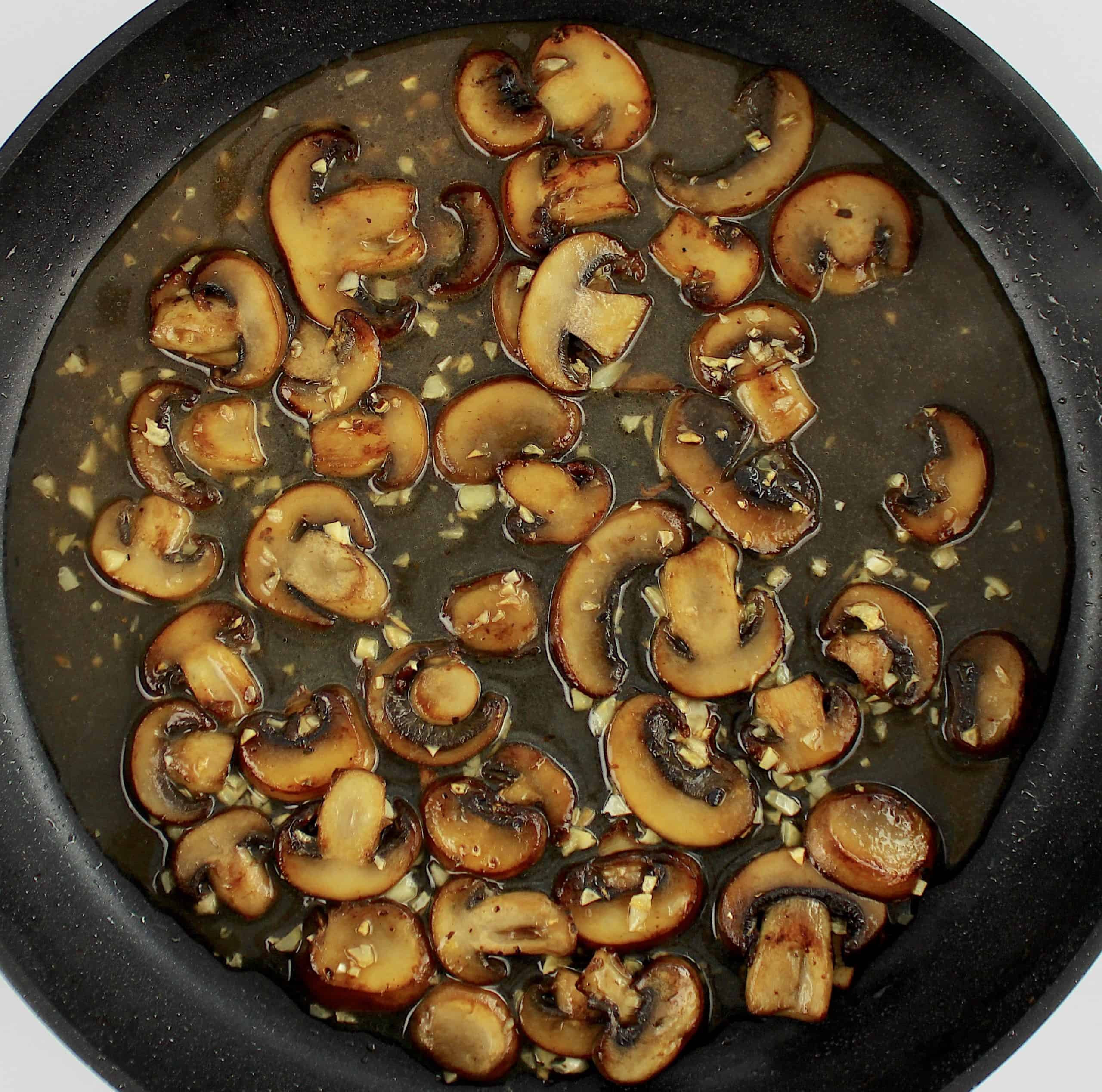 sauteed mushrooms and garlic with marsala wine in skillet