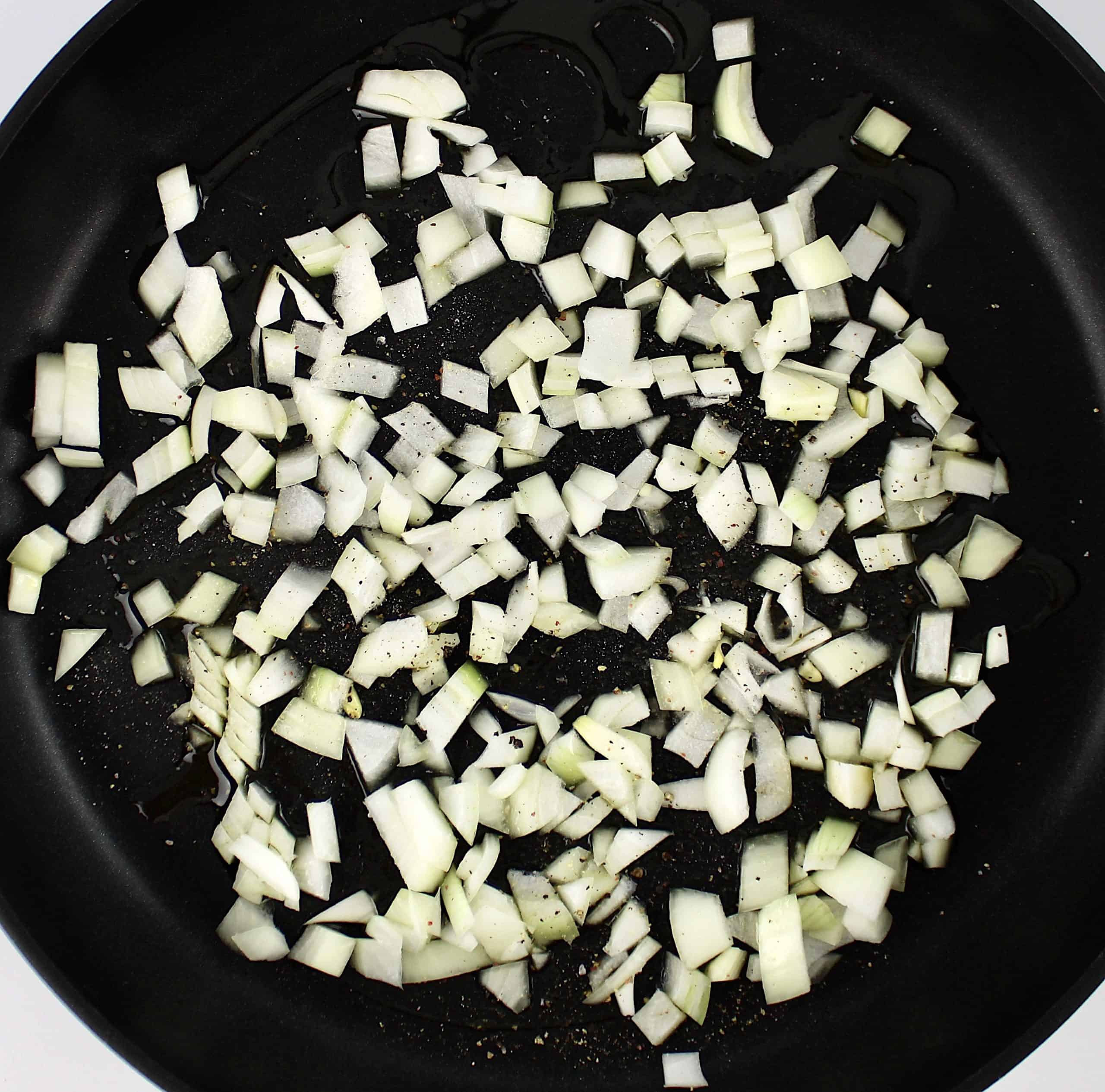diced onions sauteing in skillet