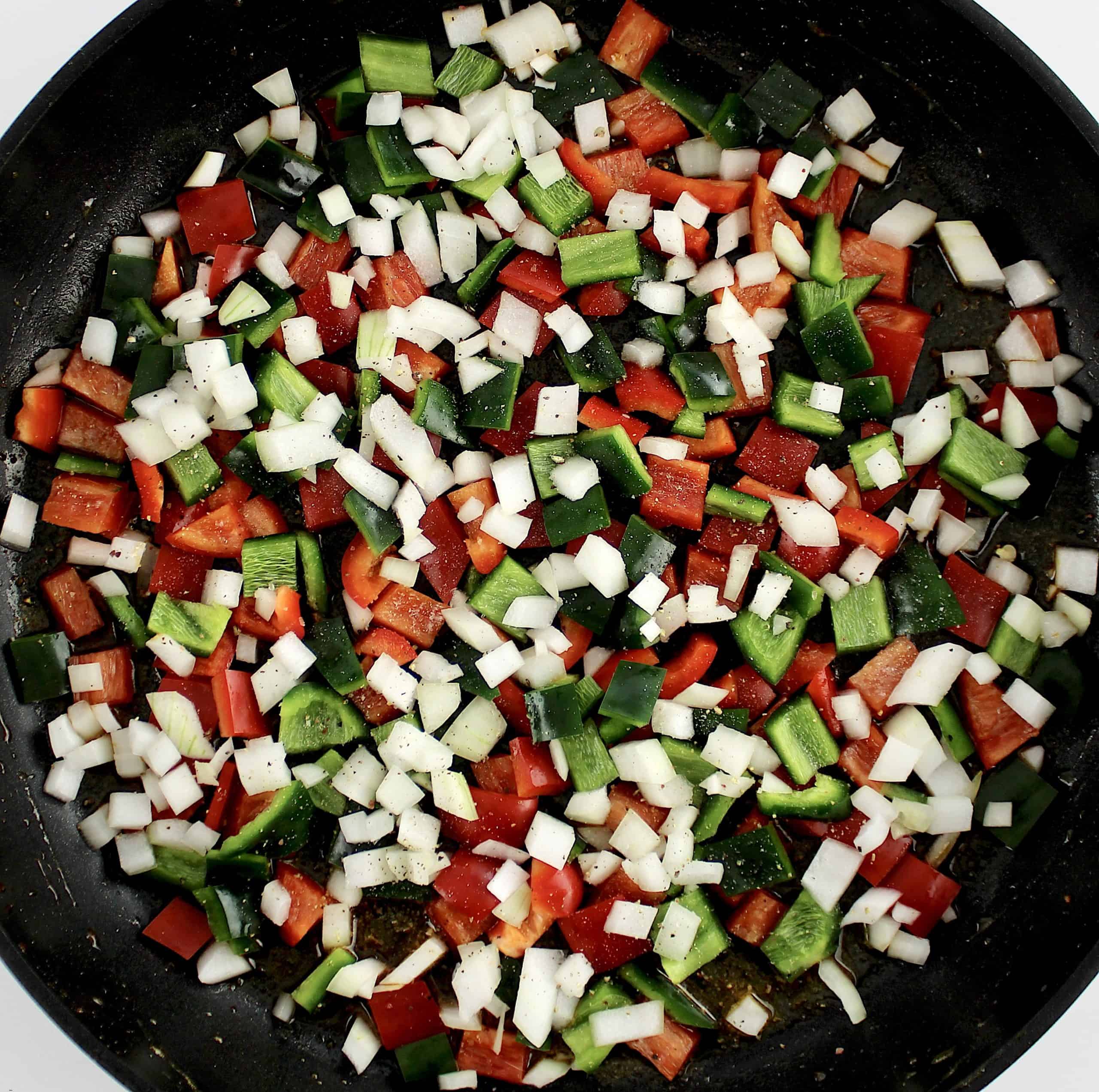diced onion, red and poblano peppers in skillet uncooked