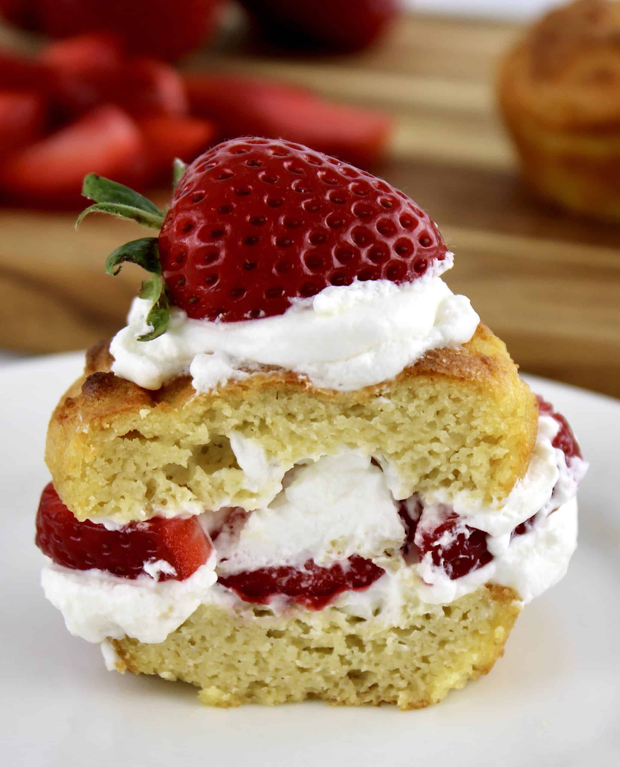 strawberry shortcake on  white plate cut in half