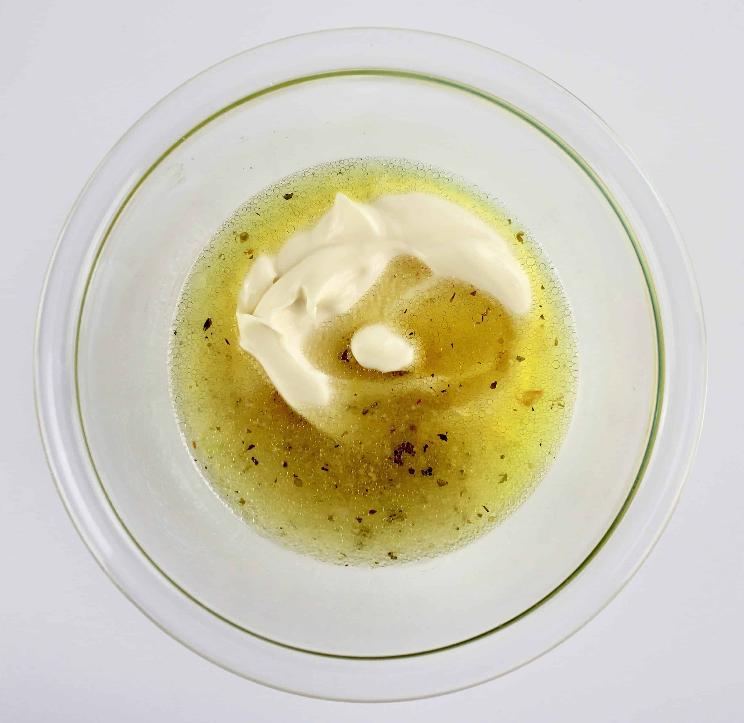 Mayonnaise and italian dressing in glass bowl unmixed