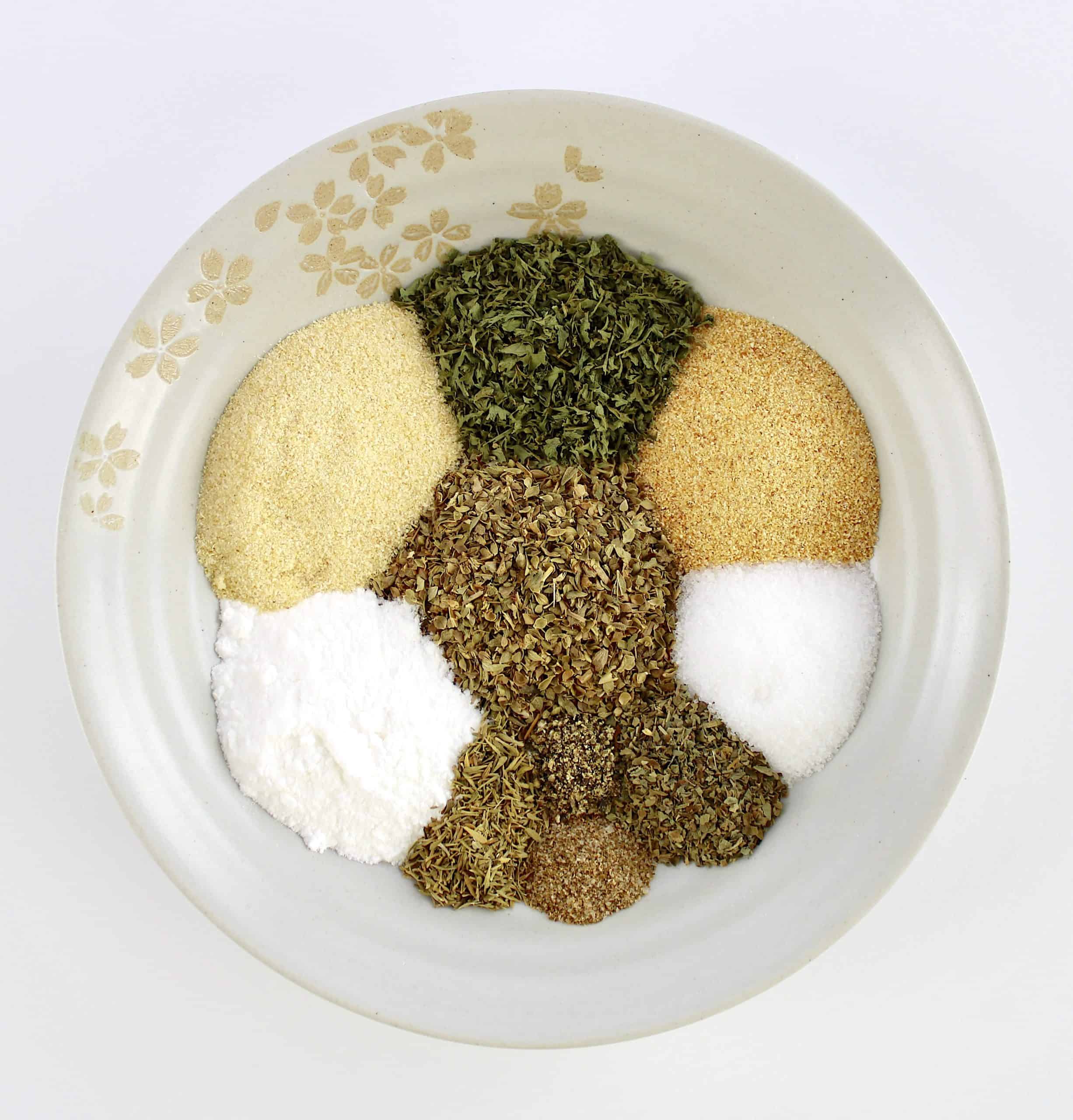 10 different herbs and spices in beige bowl unmixed
