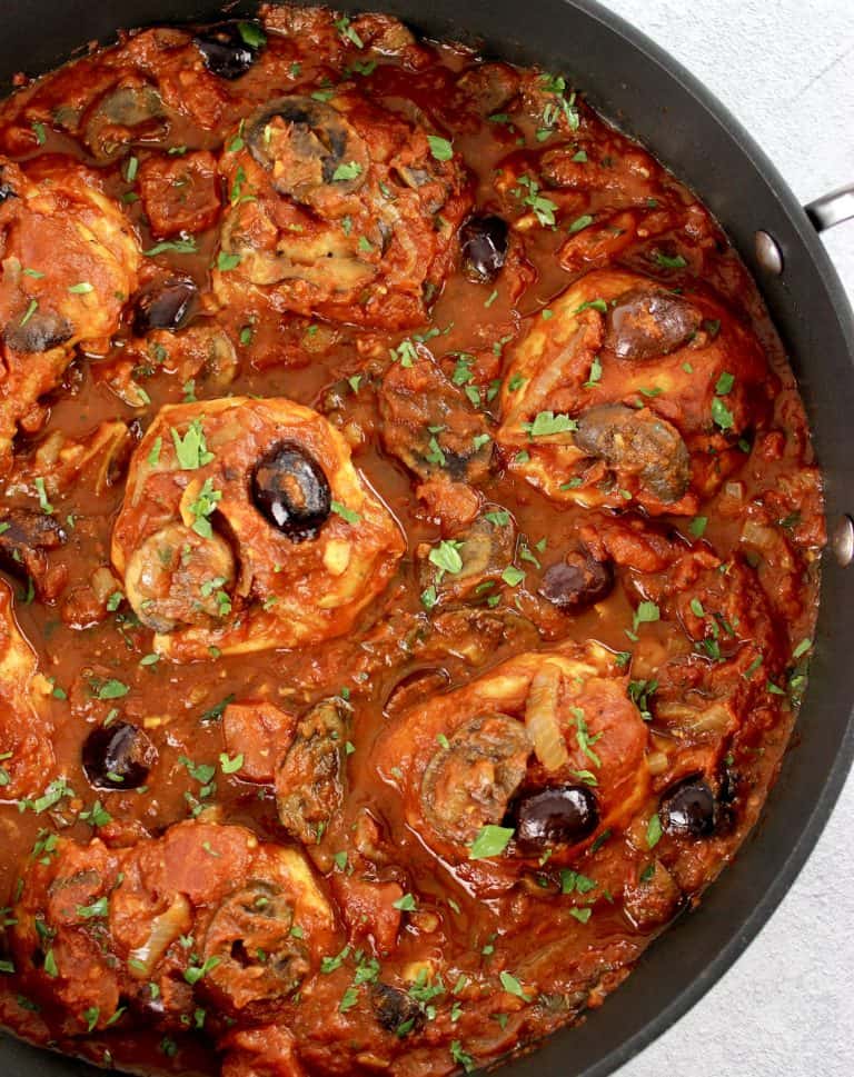Keto Chicken Cacciatore in skillet with chopped parsley on top