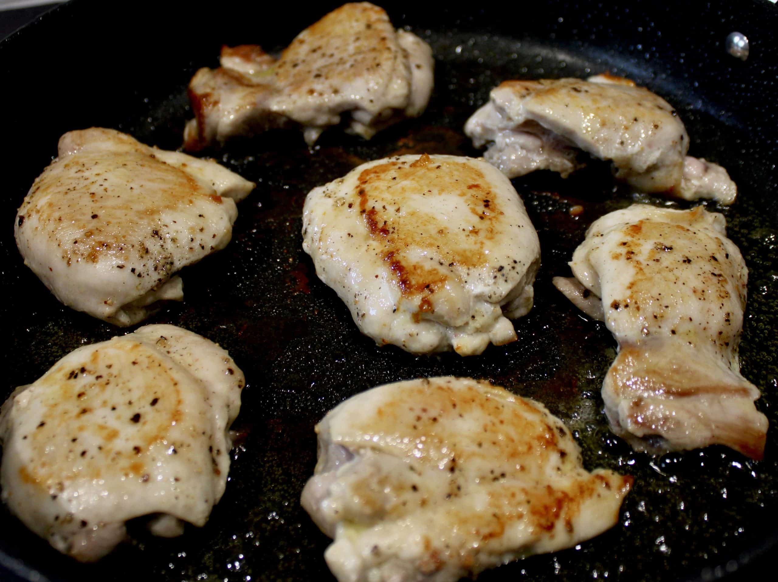 7 partially cooked chicken thighs in skillet