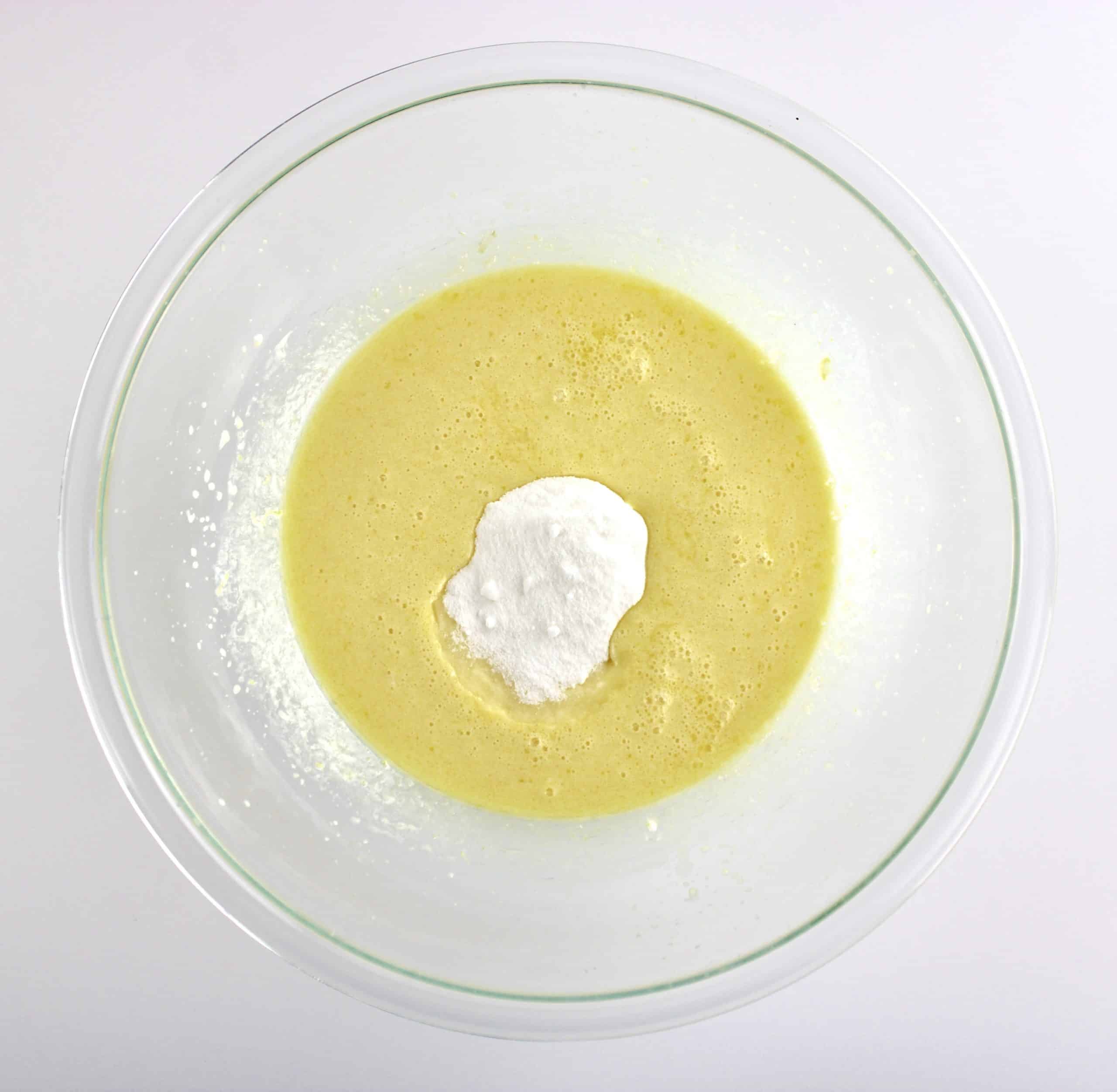 wet ingredients for lemon muffins in glass bowl with sweetener unmixed