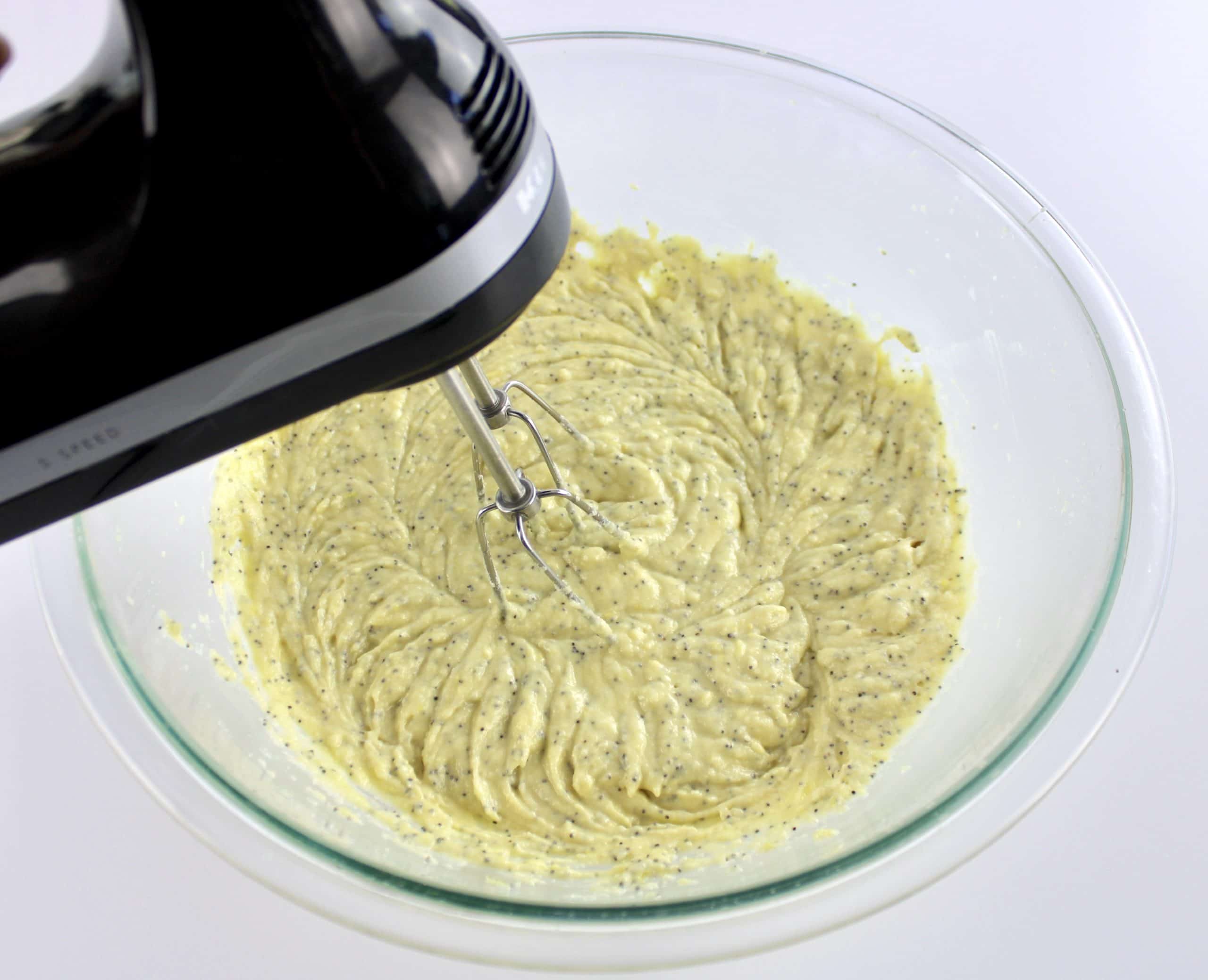 Keto Lemon Poppy Seed Muffins batter in glass bowl being mixed