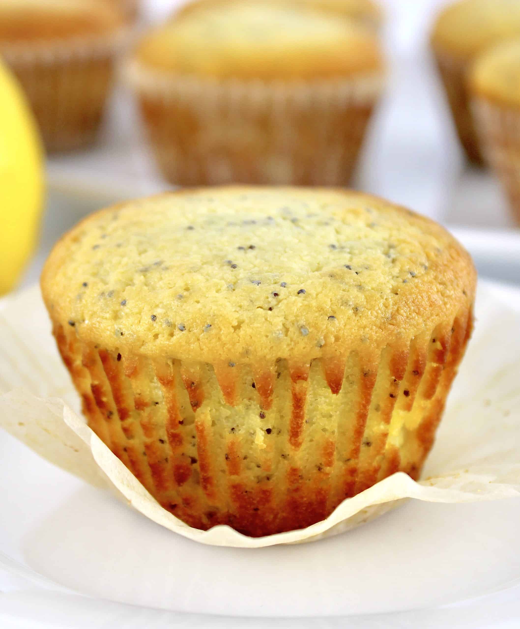 closeup of Keto Lemon Poppy Seed Muffin unwrapped on white plate