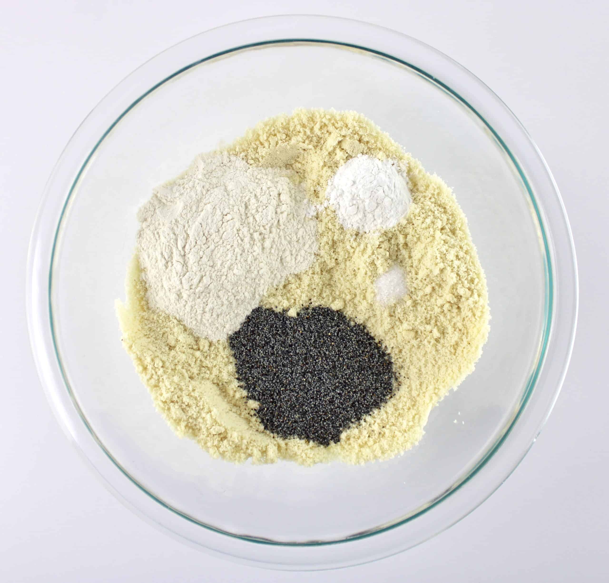 almond flour oat fiber salt and poppy seeds in glass bowl unmixed