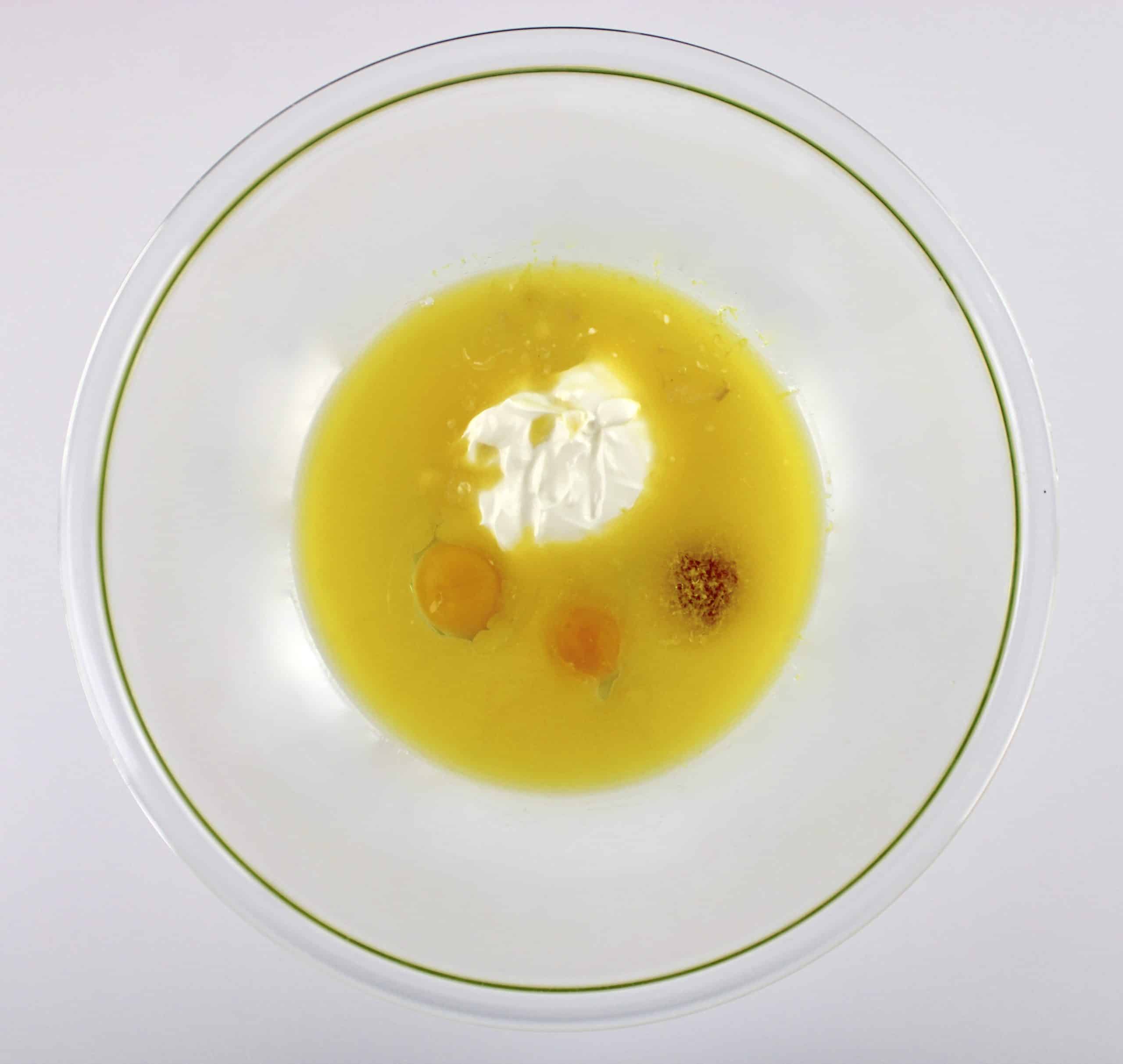 melted butter, sour cream, lemon juice and eggs in glass bowl unmixed