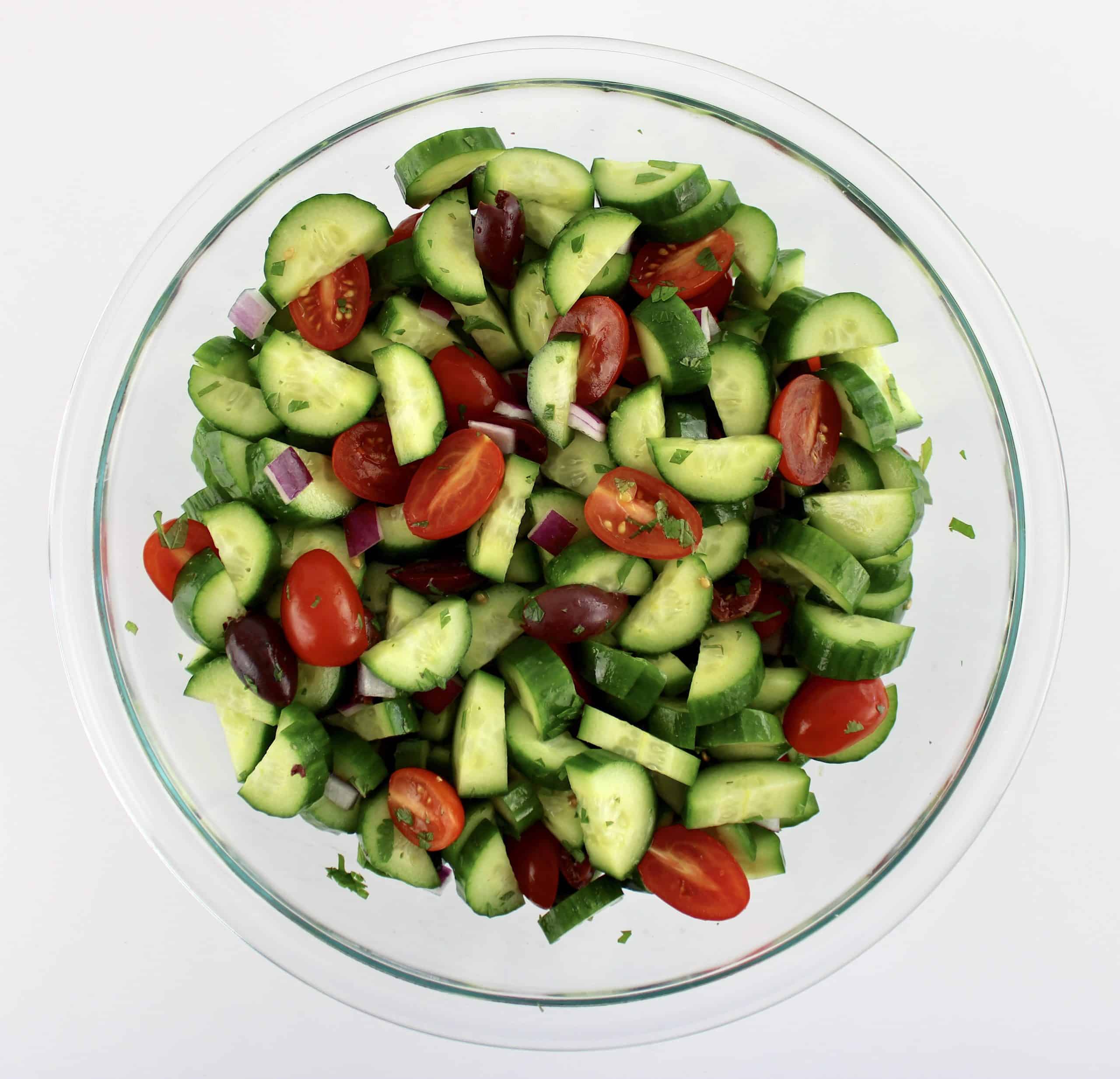 Mediterranean Cucumber Salad without dressing in glass bowl