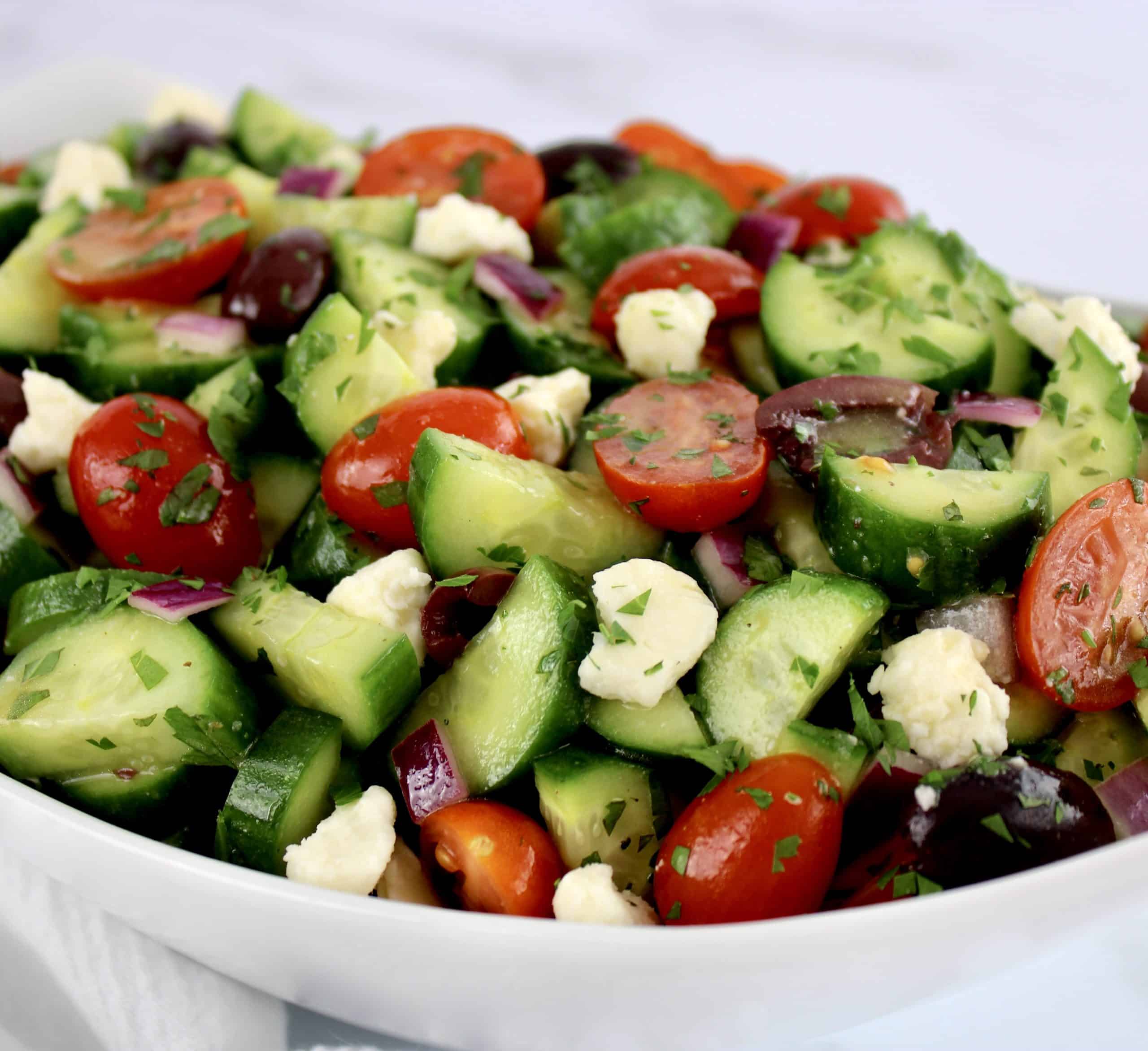 closeup of Mediterranean Cucumber Salad in white bowl
