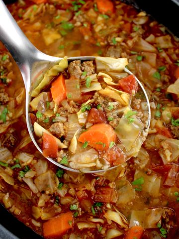 Slow Cooker Cabbage Roll Soup being scooped out of slow cooker with silver ladle