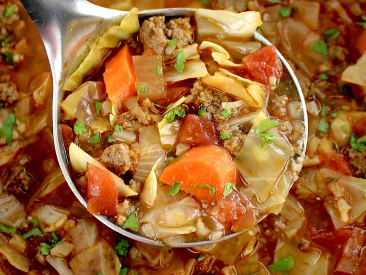 Slow Cooker Cabbage Roll Soup being scooped out of slow cooker with silver ladle