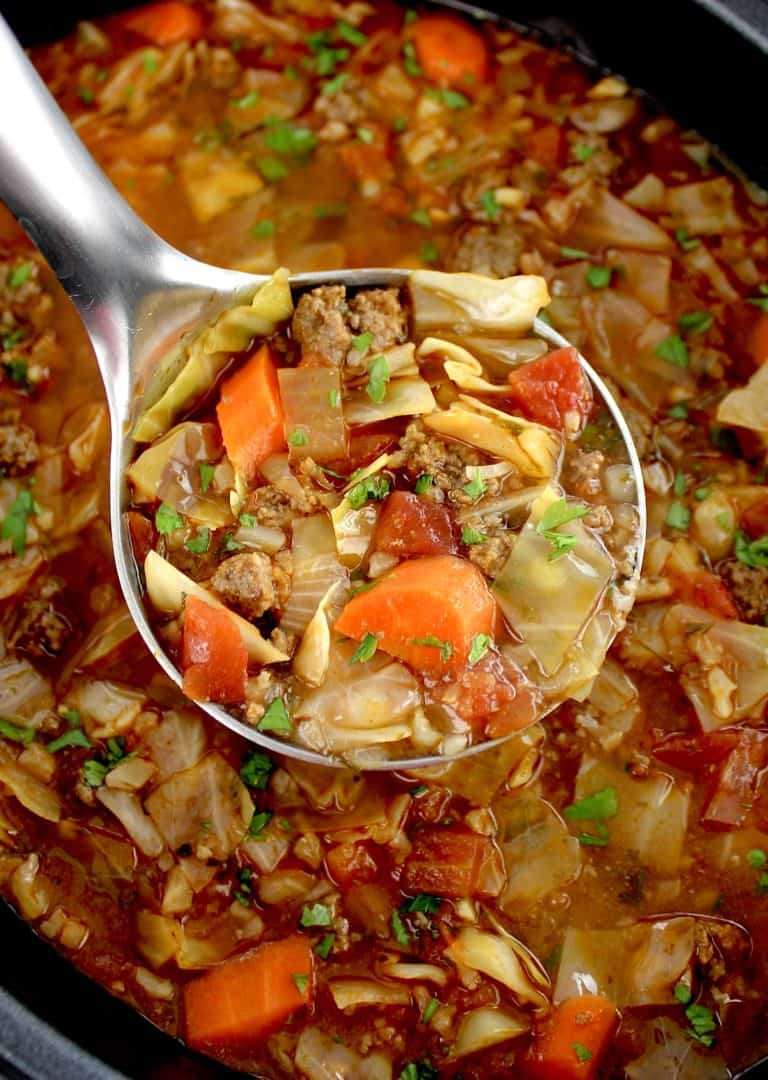 Slow Cooker Cabbage Roll Soup being scooped out of slow cooker with silver ladle
