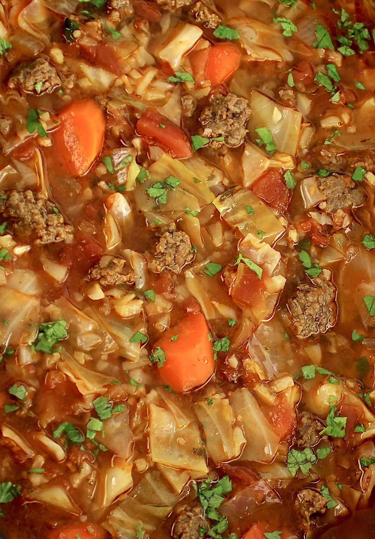 closeup of Slow Cooker Cabbage Roll Soup with chopped parsley on top