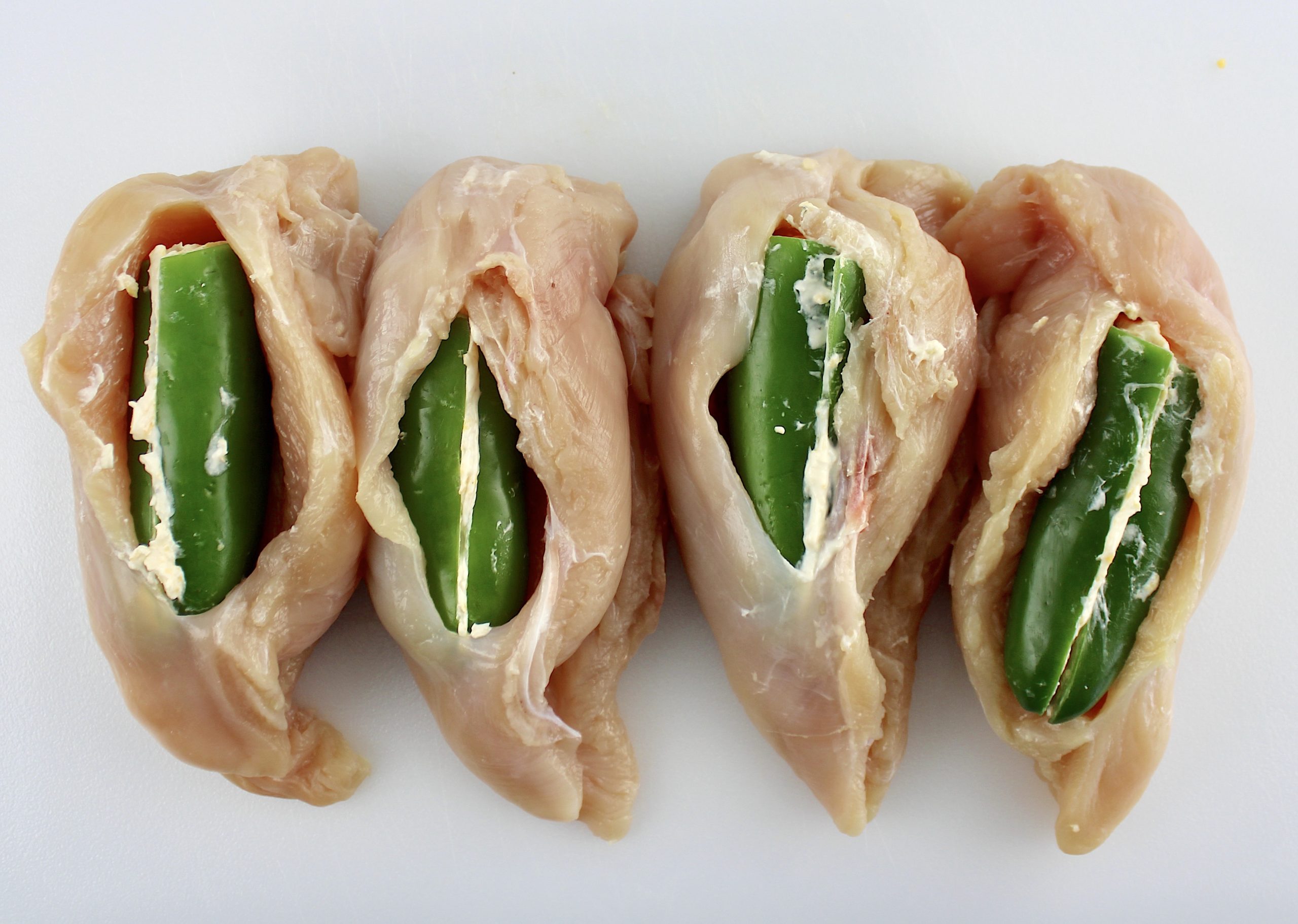 4 chicken breasts cut open with jalapenos inside
