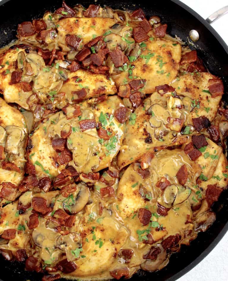 Creamy Bacon Mushroom Chicken in skillet with parsley garnish