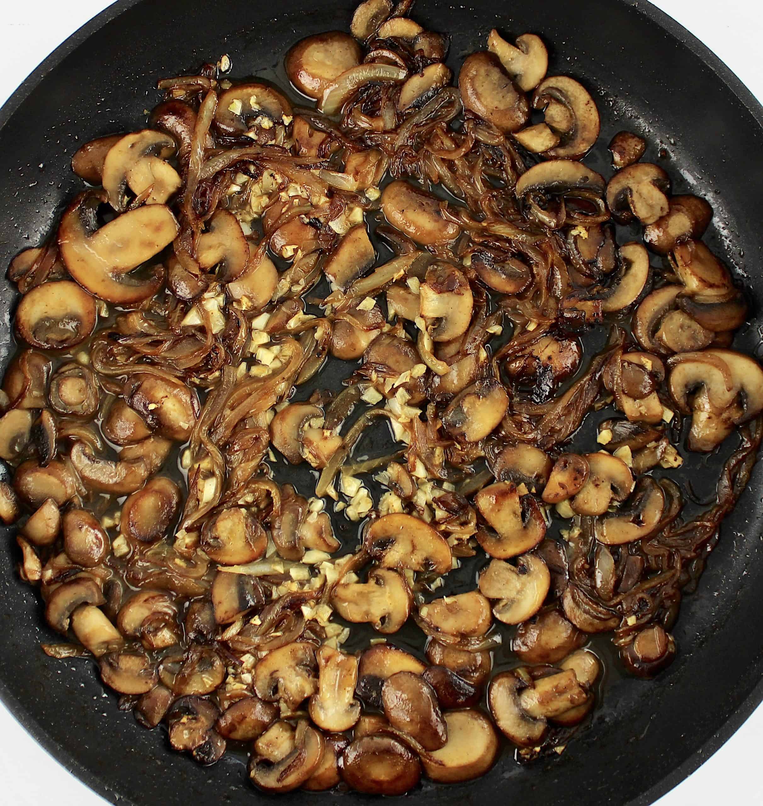 cooked sliced mushrooms onions and garlic in skillet with wine