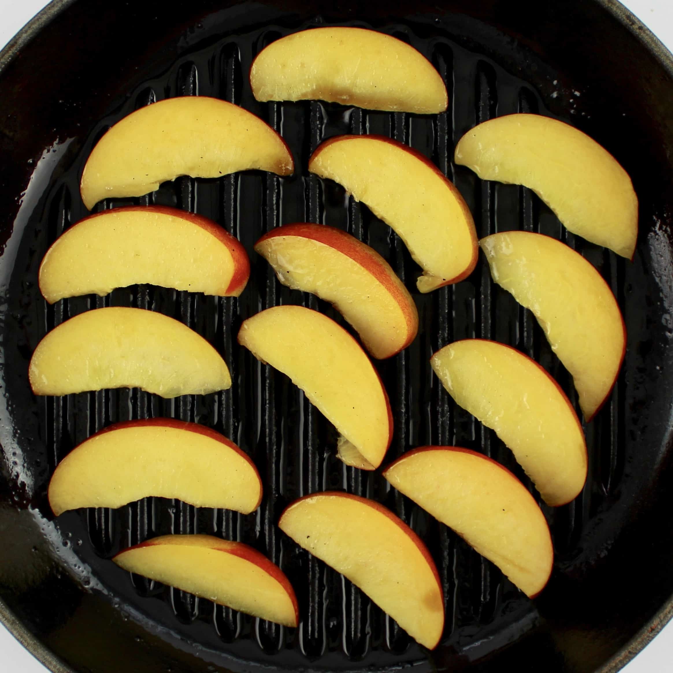 slices of peaches on grill pan uncooked