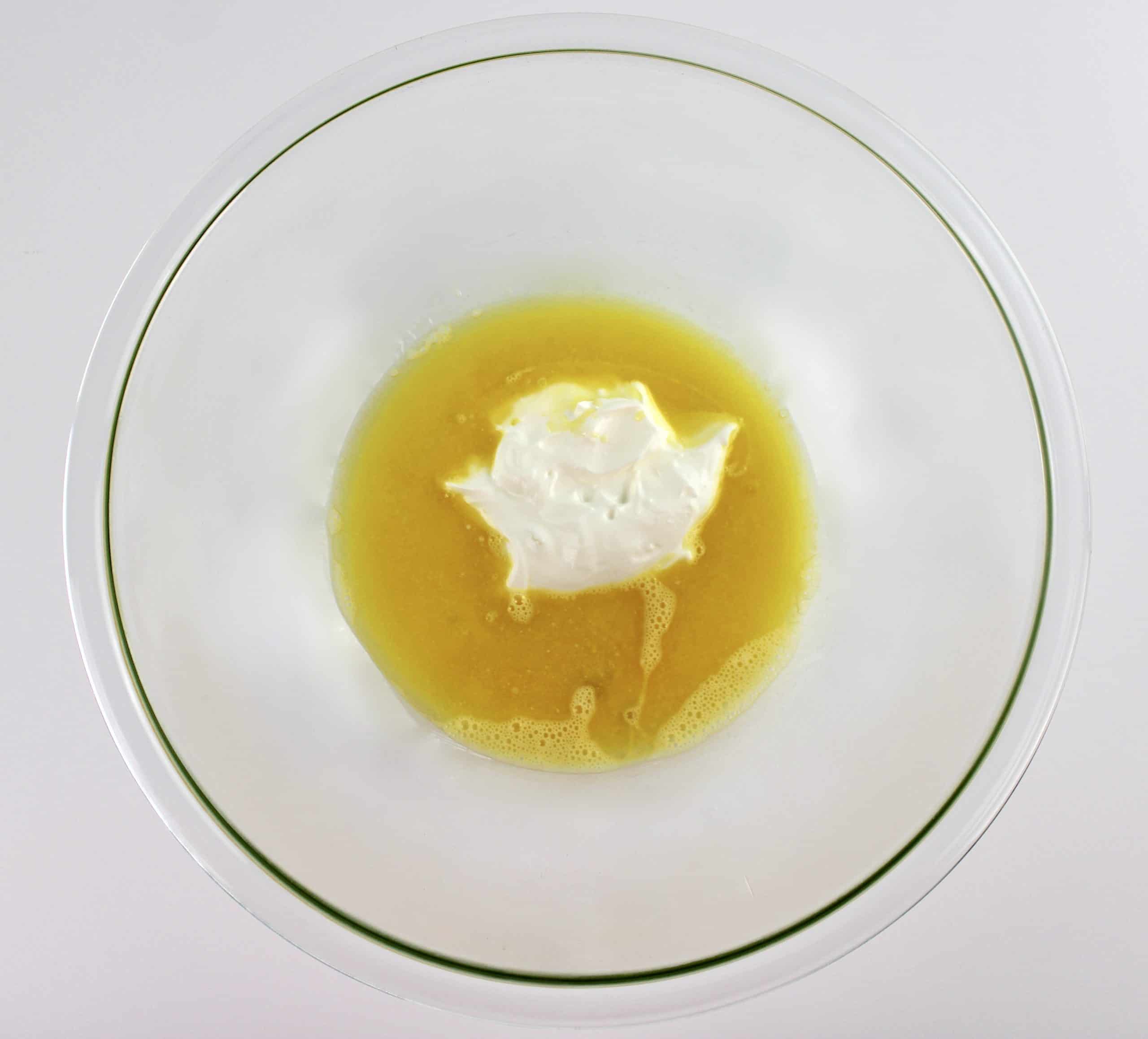 beaten eggs, melted butter and sour cream in glass bowl unmixed