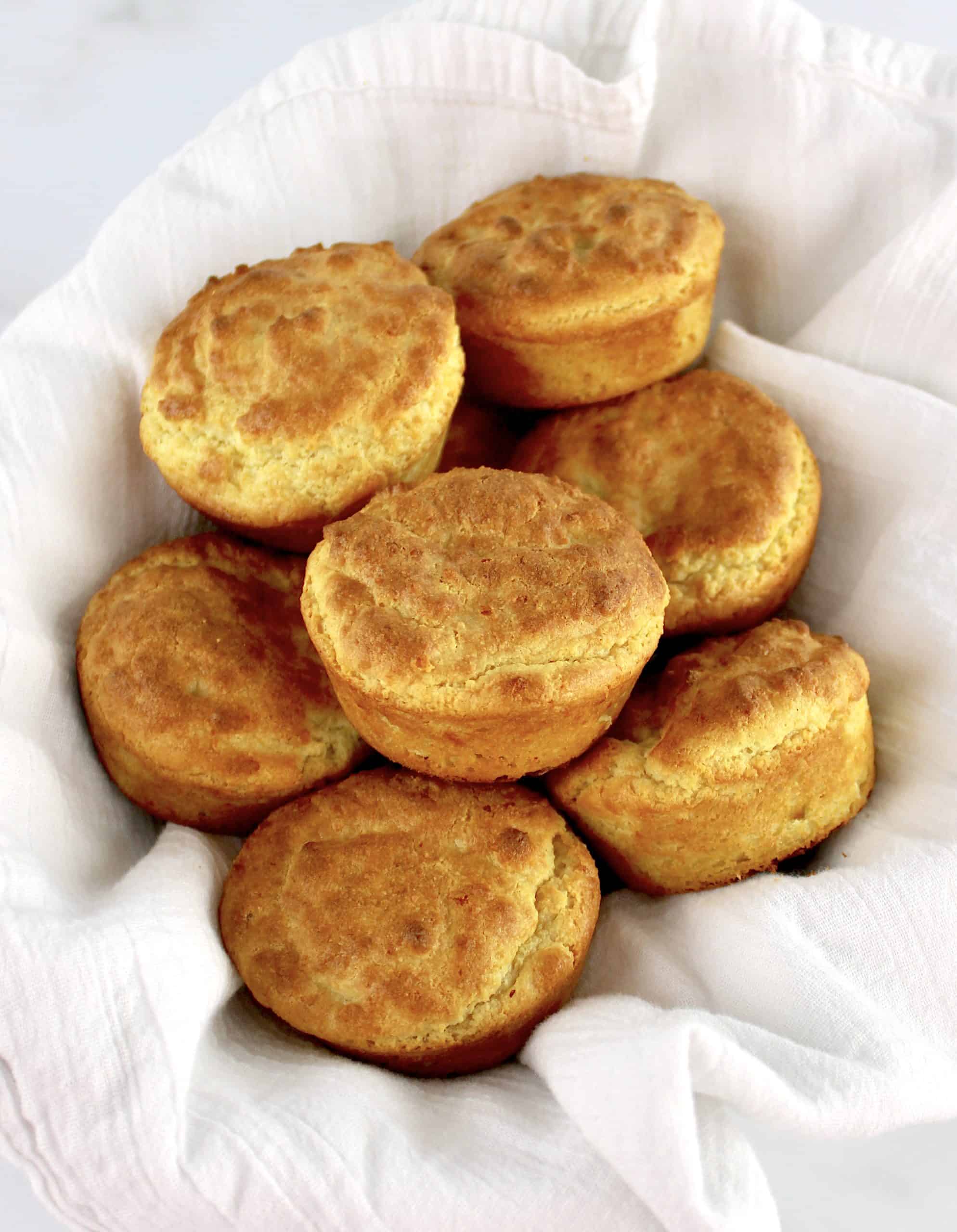 Keto Biscuits piled up in bowl with white napkin