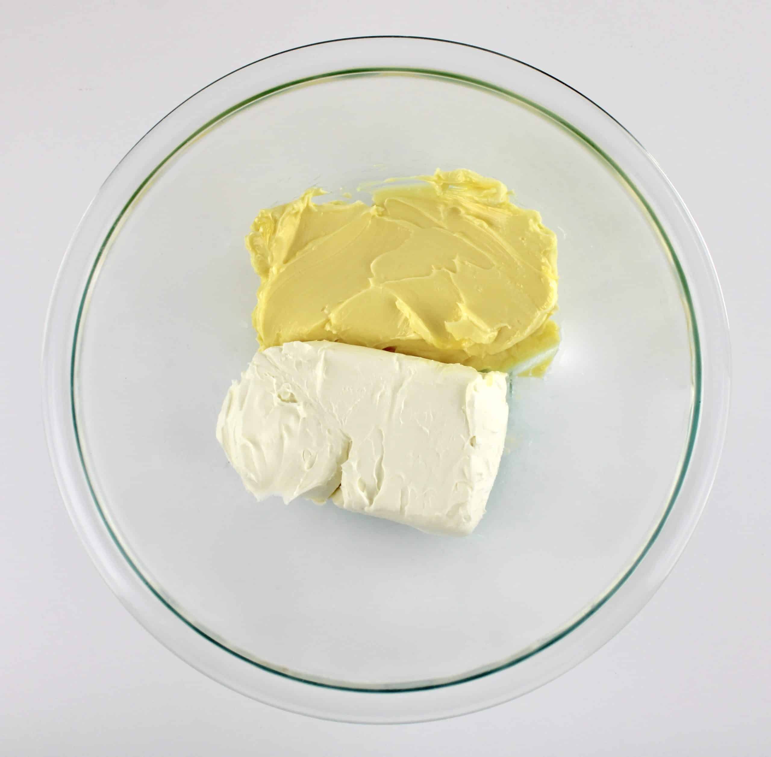 cream cheese and butter in glass bowl unmixed