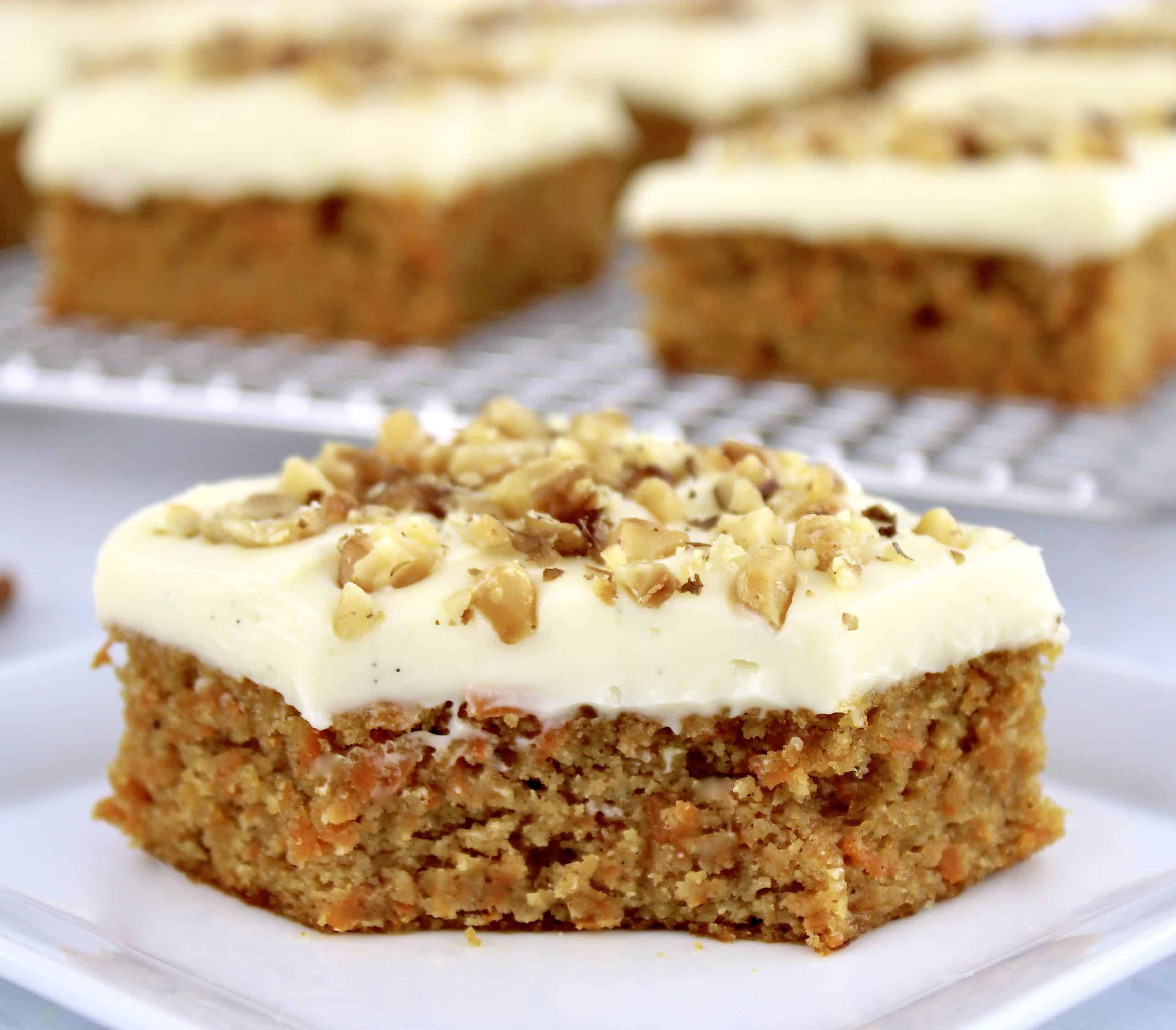 Keto Carrot Cake Bar on white square plate with bite missing