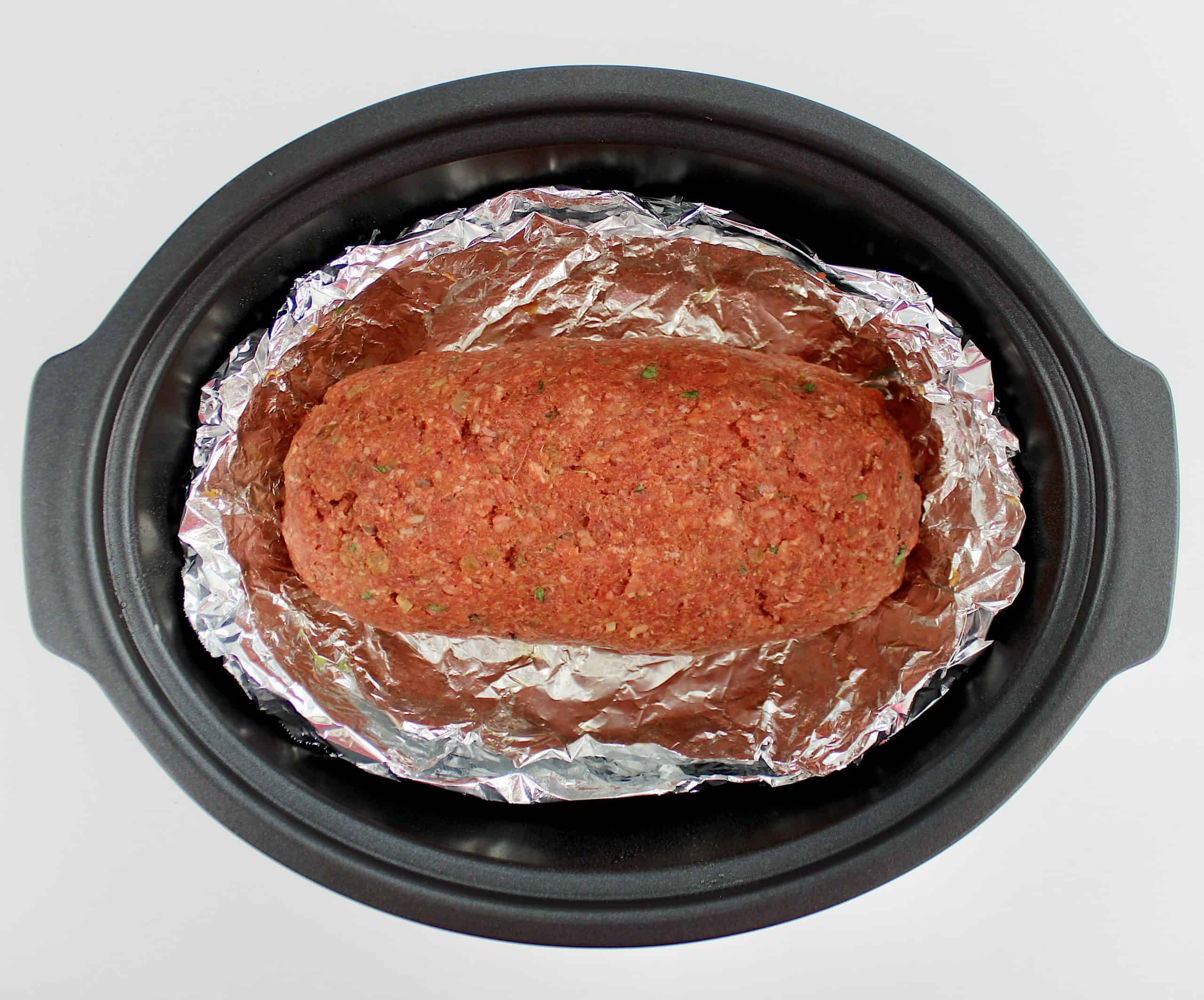 Keto Crockpot Meatloaf uncooked in foil lined slow cooker