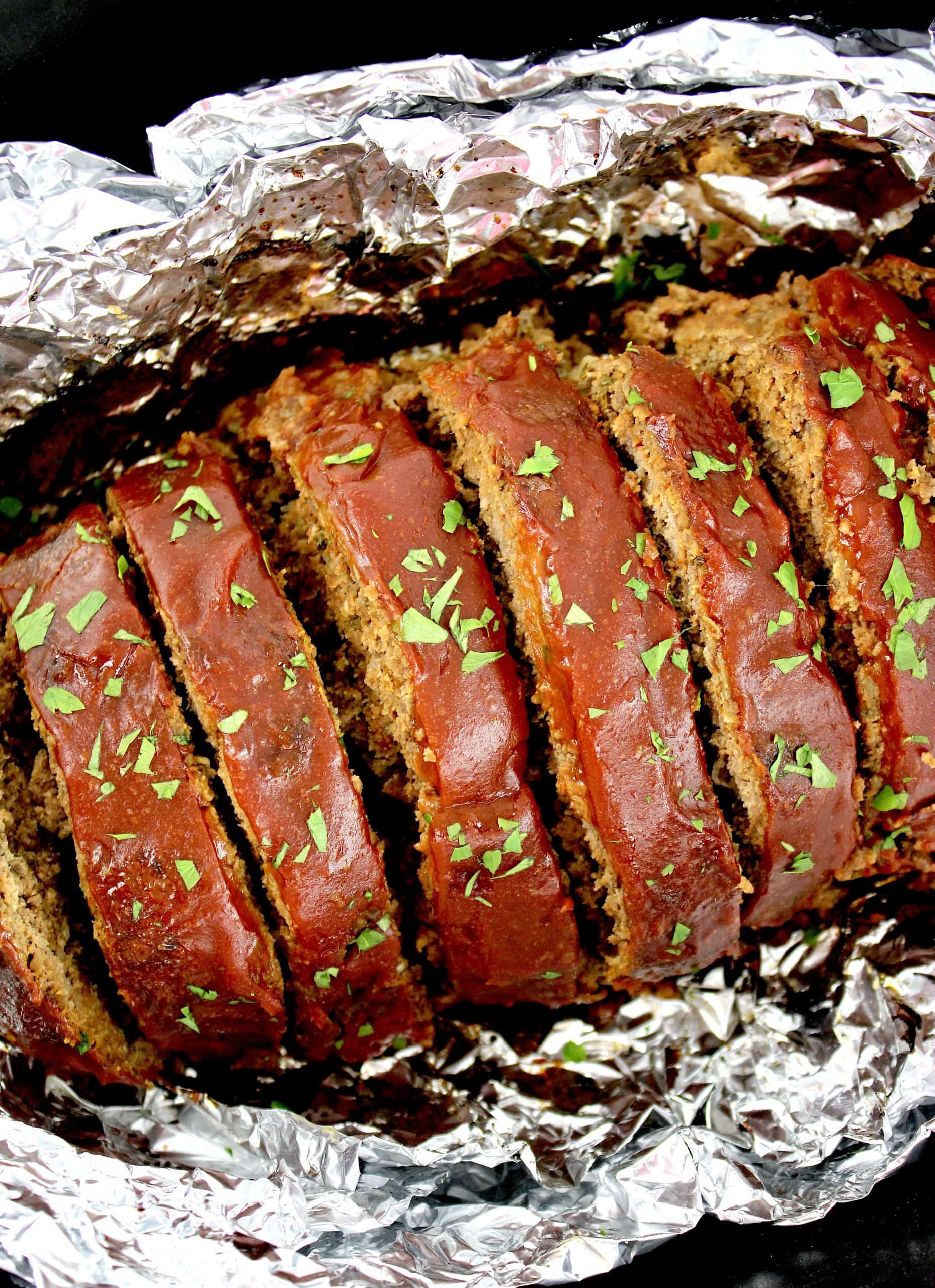 Keto Crockpot Meatloaf sliced in foil lined slow cooker