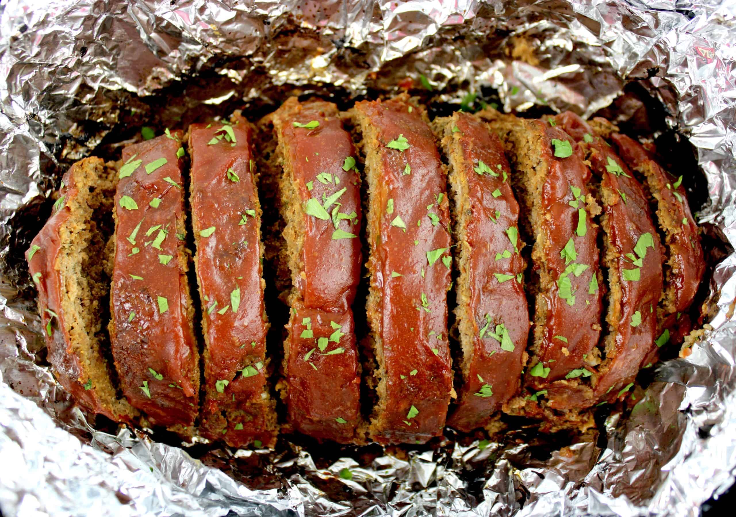 Keto Crockpot Meatloaf sliced in foil lined slow cooker